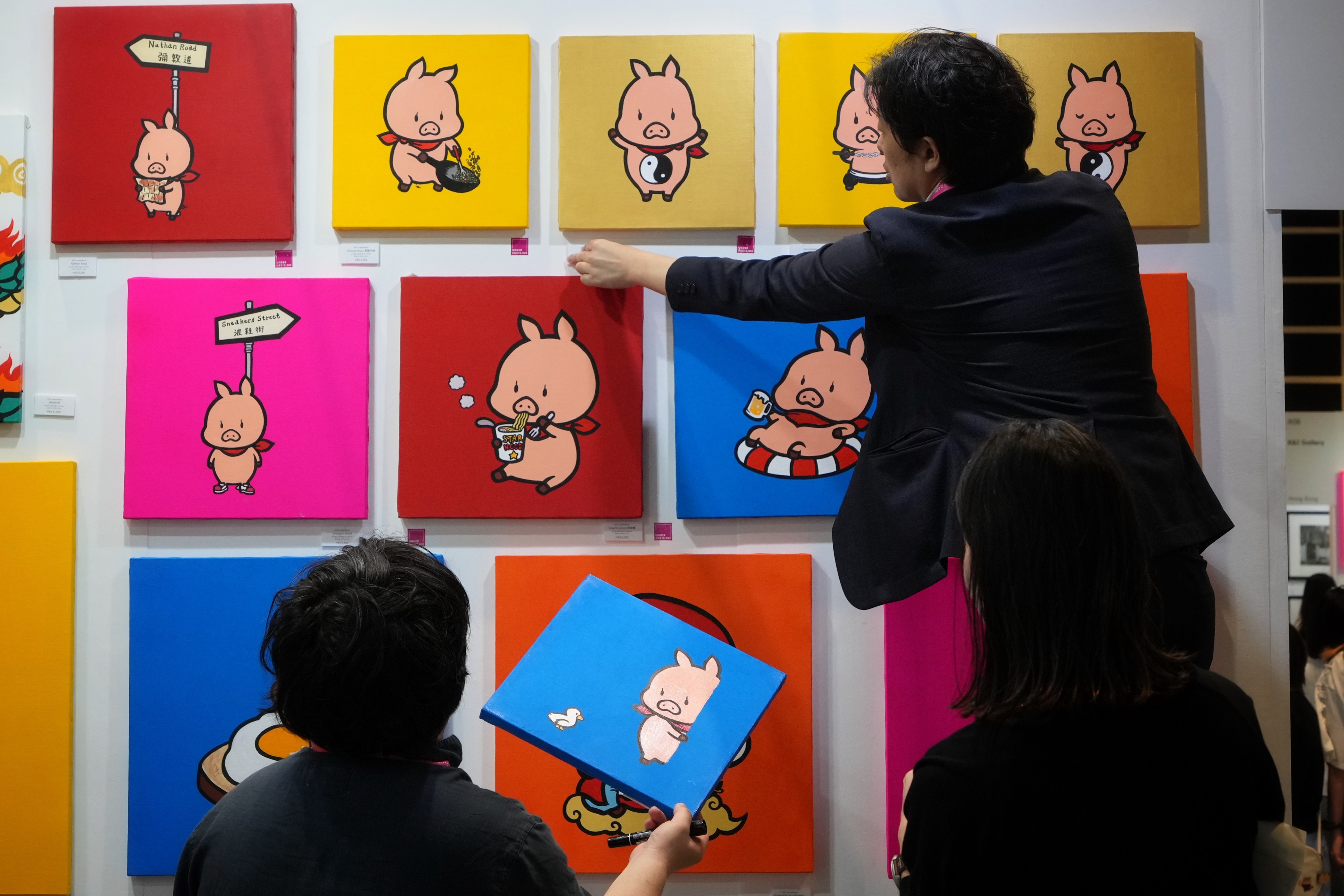 Gallery staff arrange artwork by Shu Matsukura at the Affordable Art Fair 2024 held at Hong Kong Convention and Exhibition Centre. Photo: Elson Li