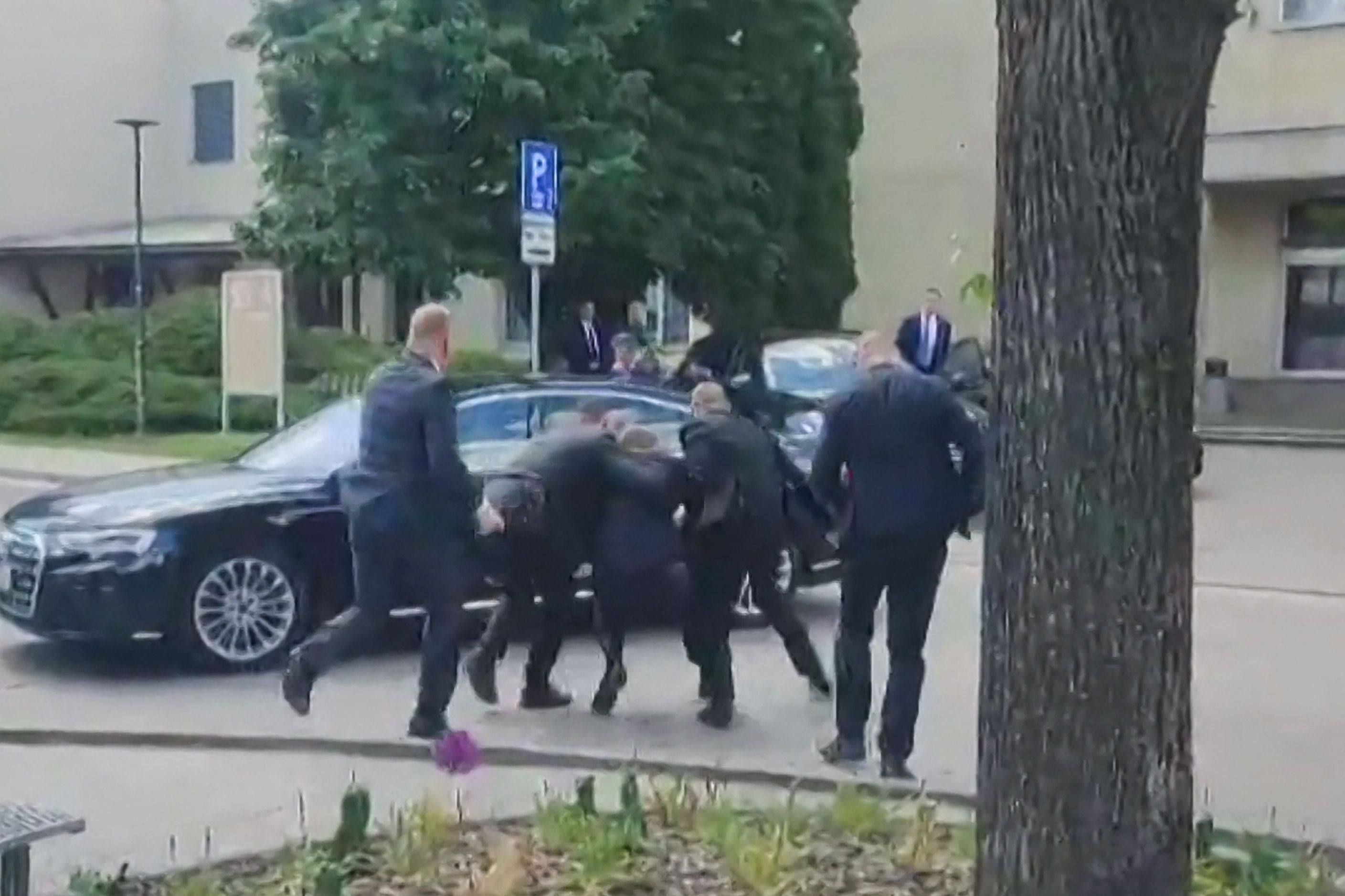 Security personnel carry Slovakia’s Prime Minister Robert Fico towards a vehicle after he was shot. Photo: RTVS via AFP