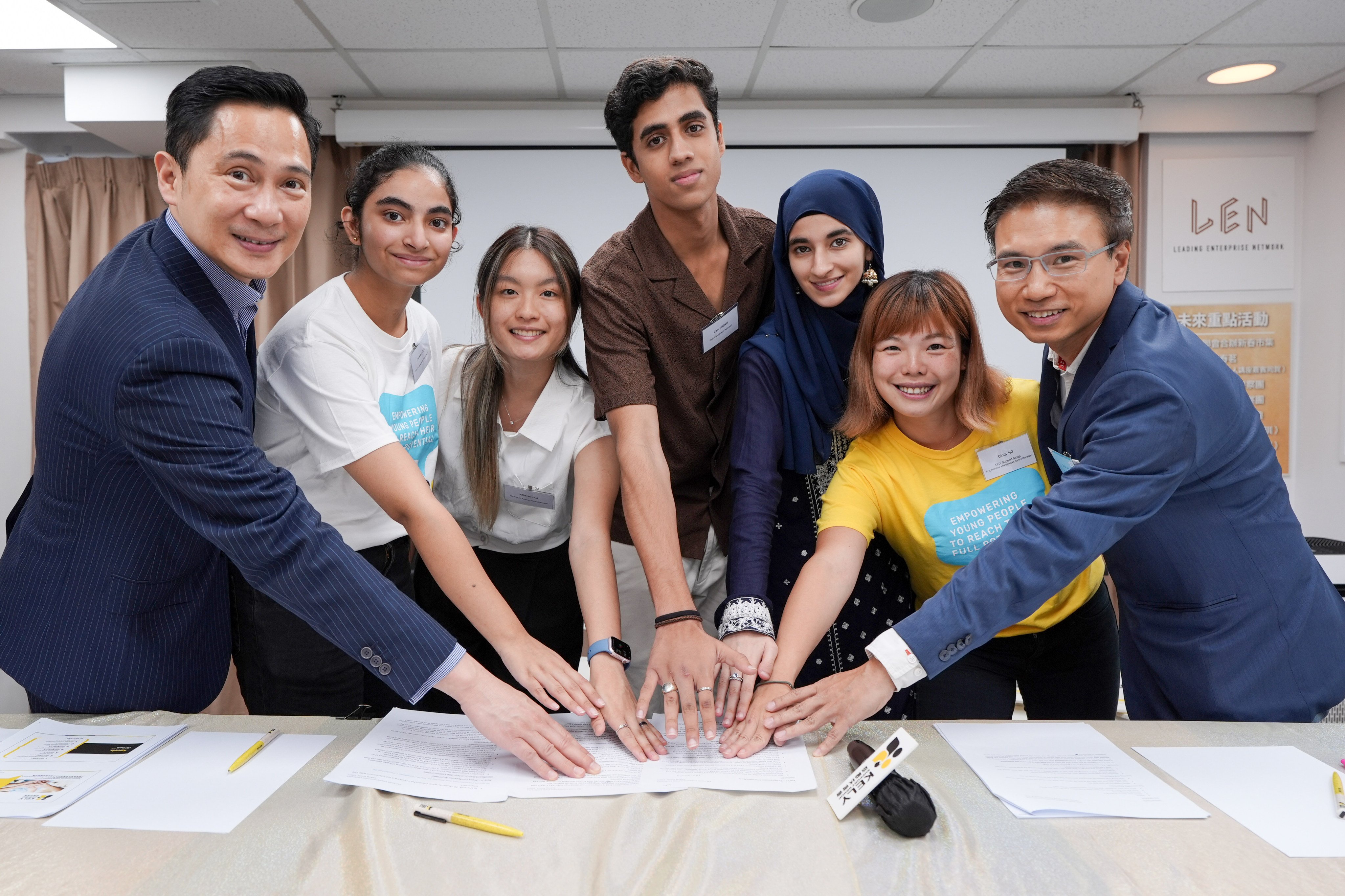 (L-R) Head of Corporate Affairs of Prudential Hong Kong Limited Wayne Fong Wai, KELY Youth Advisory Council Member Gurleen Kaur, KELY Youth Advisory Council Member Athena Lau, Open Door Work Placement Programme student participant Zain Sheikh, Open Door Work Placement Programme student participant Atteqa Kahn, KELY Youth Advisory Council Member Gurleen Kaur, Programmes and Services Senior Manager of KELY Support Group Cindy Ng, and Director and Founder of AHE Creation Limited Jack Law pose for photos at a press conference by KELY Support Group. Photo: Eugene Lee