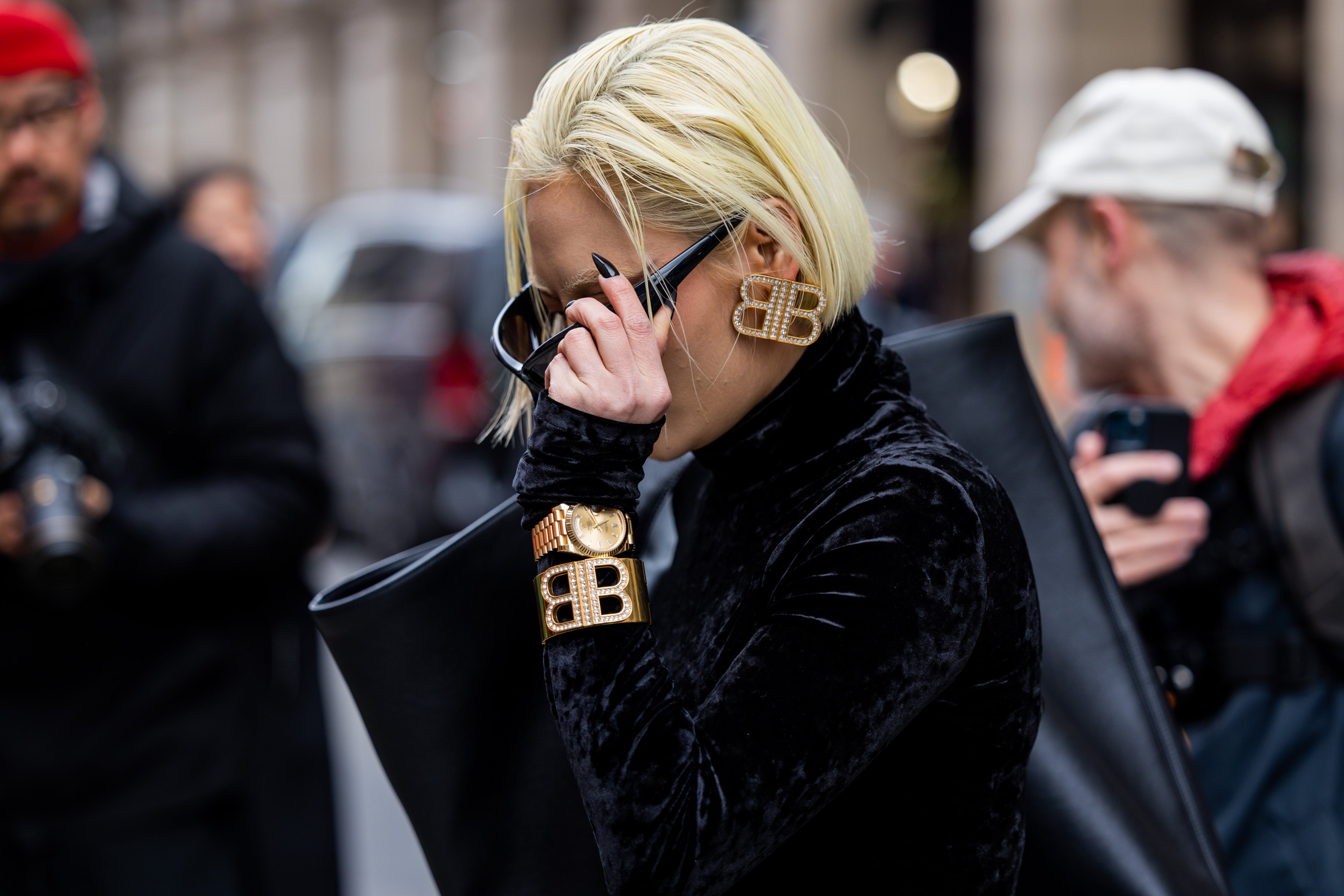 A guest wears earrings and a bracelet outside Balenciaga’s Paris Fashion Week womenswear autumn/winter show in March 2023, in Paris, France. Photo: Getty Images