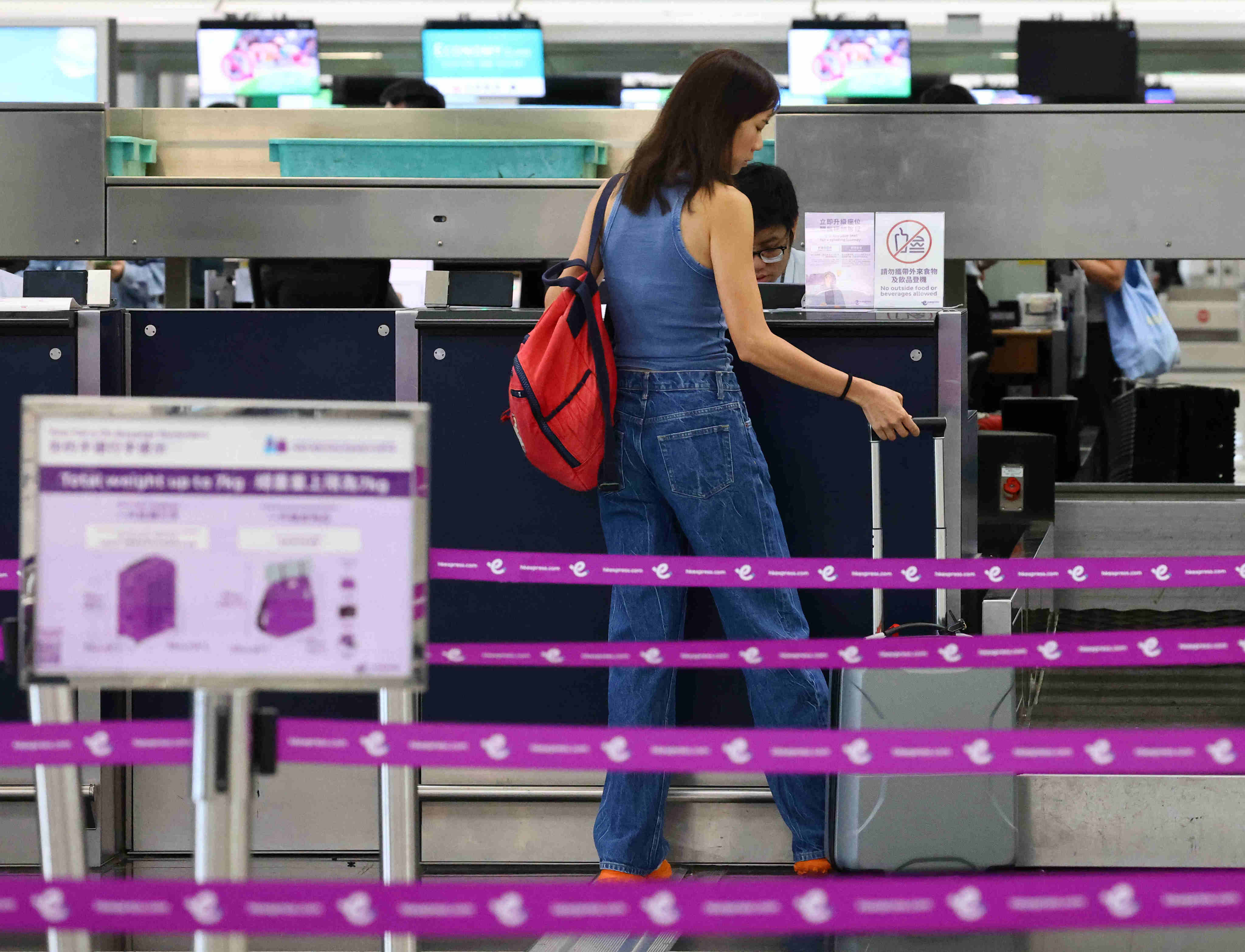 A passenger handles luggage at an HK Express counter at Hong Kong International Airport on May 8. Photo: Dickson Lee
