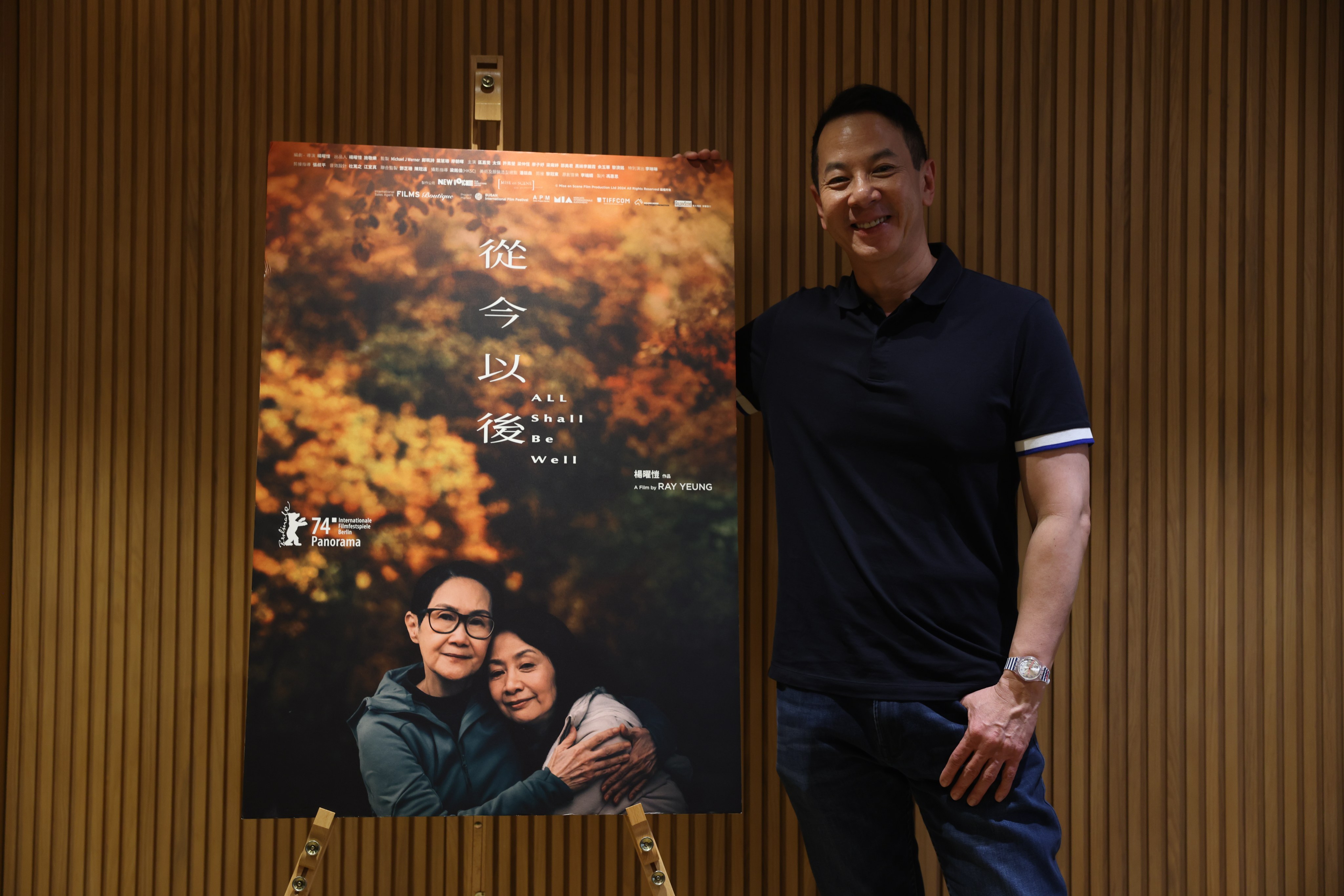 Ray Yeung, director of the film “All Shall Be Well,” poses with a movie poster at the Golden Scene Office in Yau Ma Tei. Photo: Yik Yeung-man