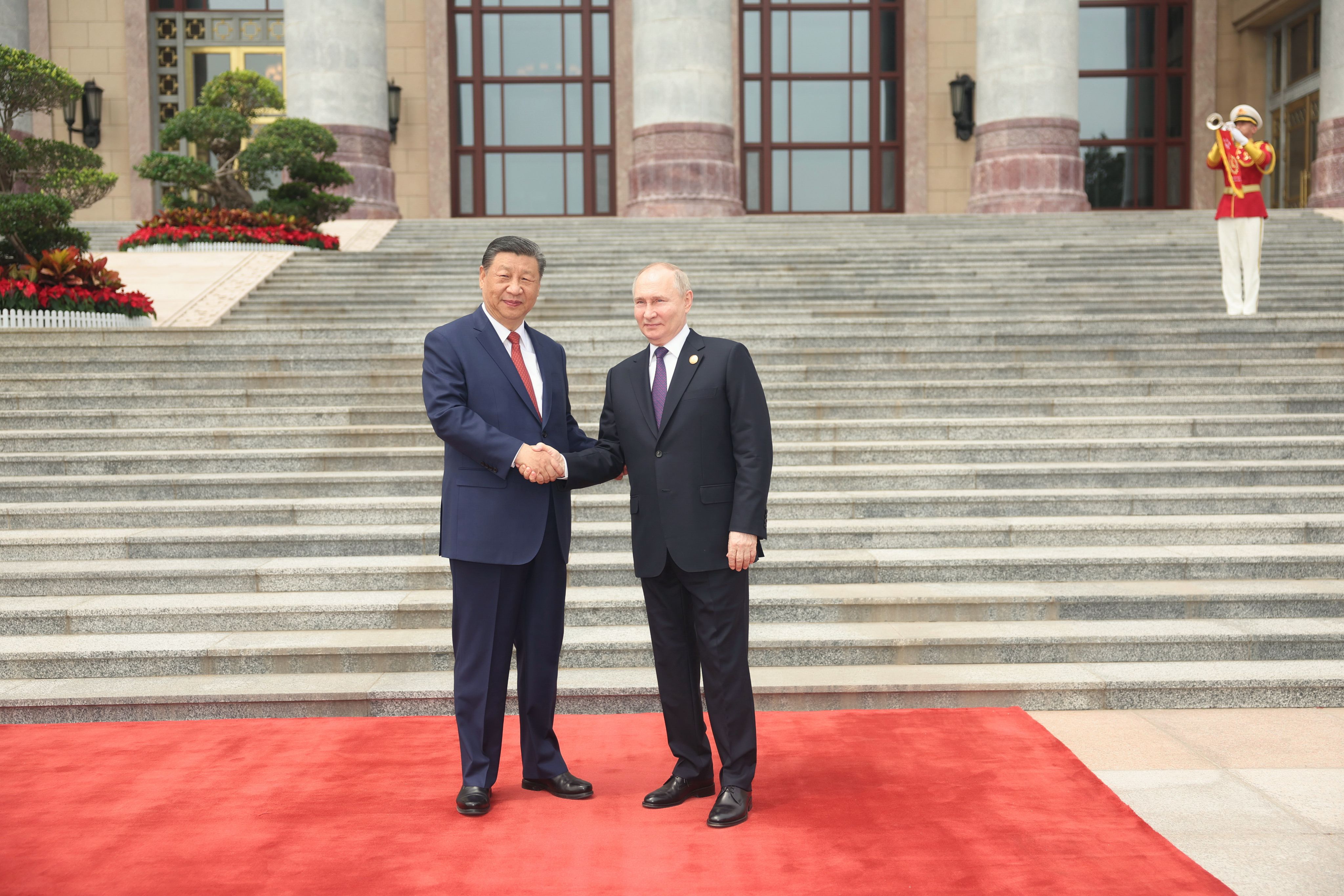 Russian President Vladimir Putin and Chinese President Xi Jinping shake hands outside the east gate of the Great Hall of the People in Beijing on Thursday. Photo: Xinhua
