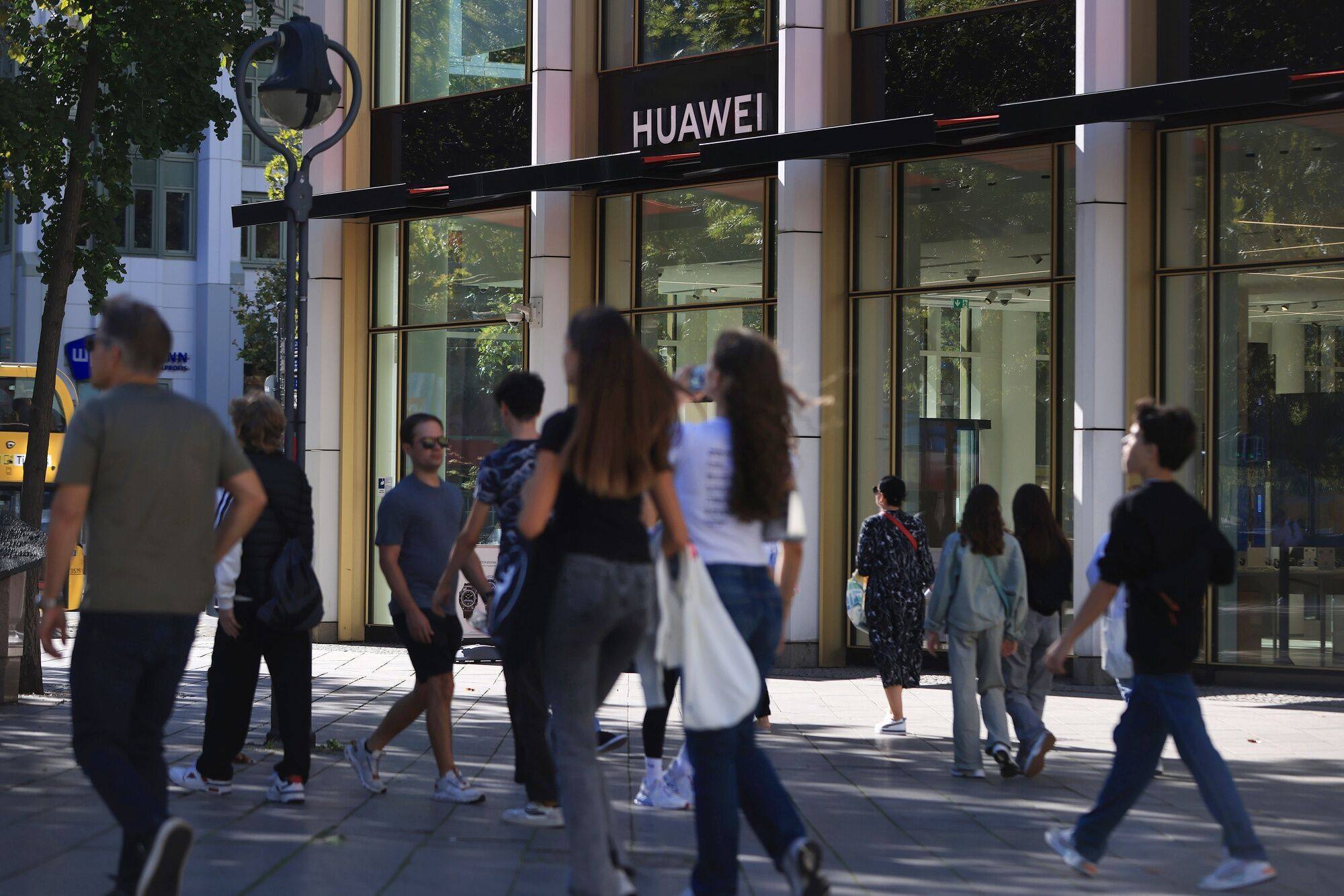Pedestrians outside a Huawei store in Berlin, Germany. Photo: Bloomberg
