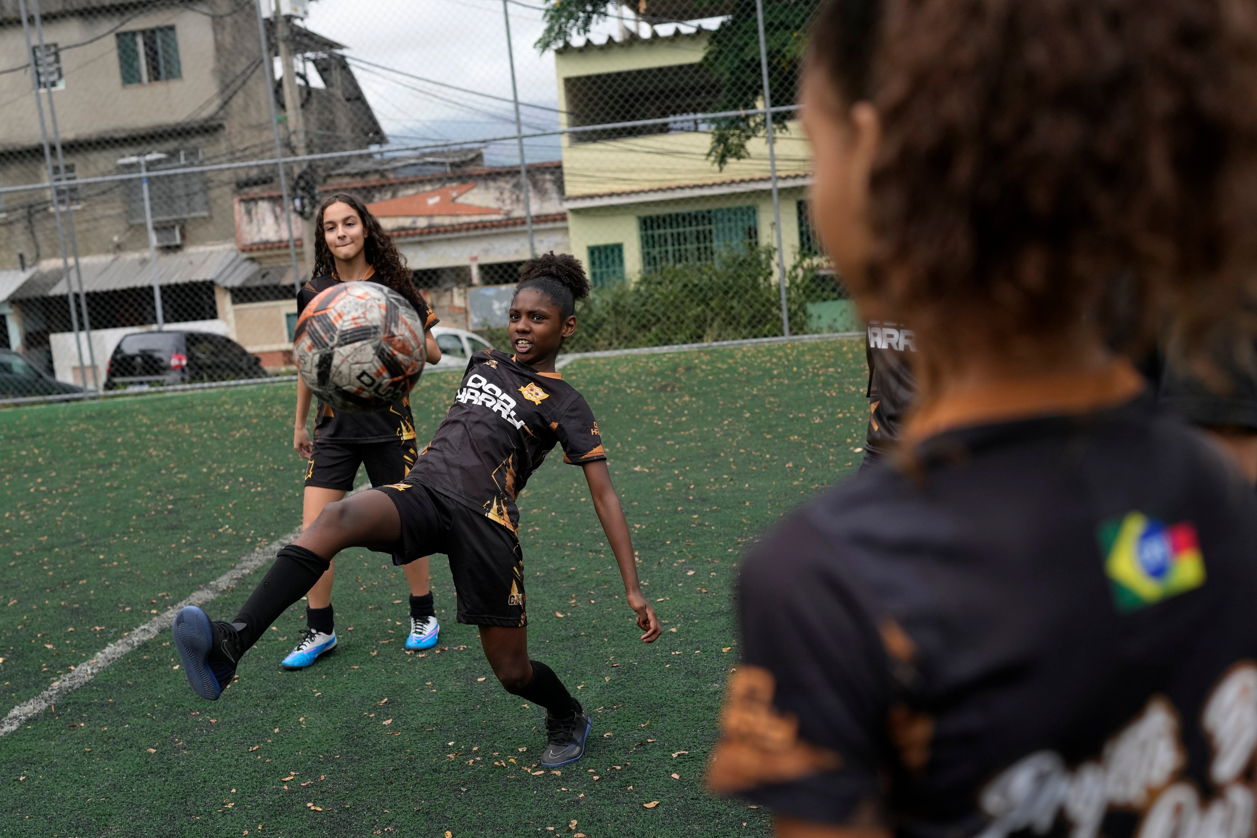 Young women take part in football training at the Complexo da Alemao favela in Rio de Janeiro. A five-time champion in men’s soccer, more than any other country, Brazil has yet to win its first Women’s World Cup trophy. Photo: AP