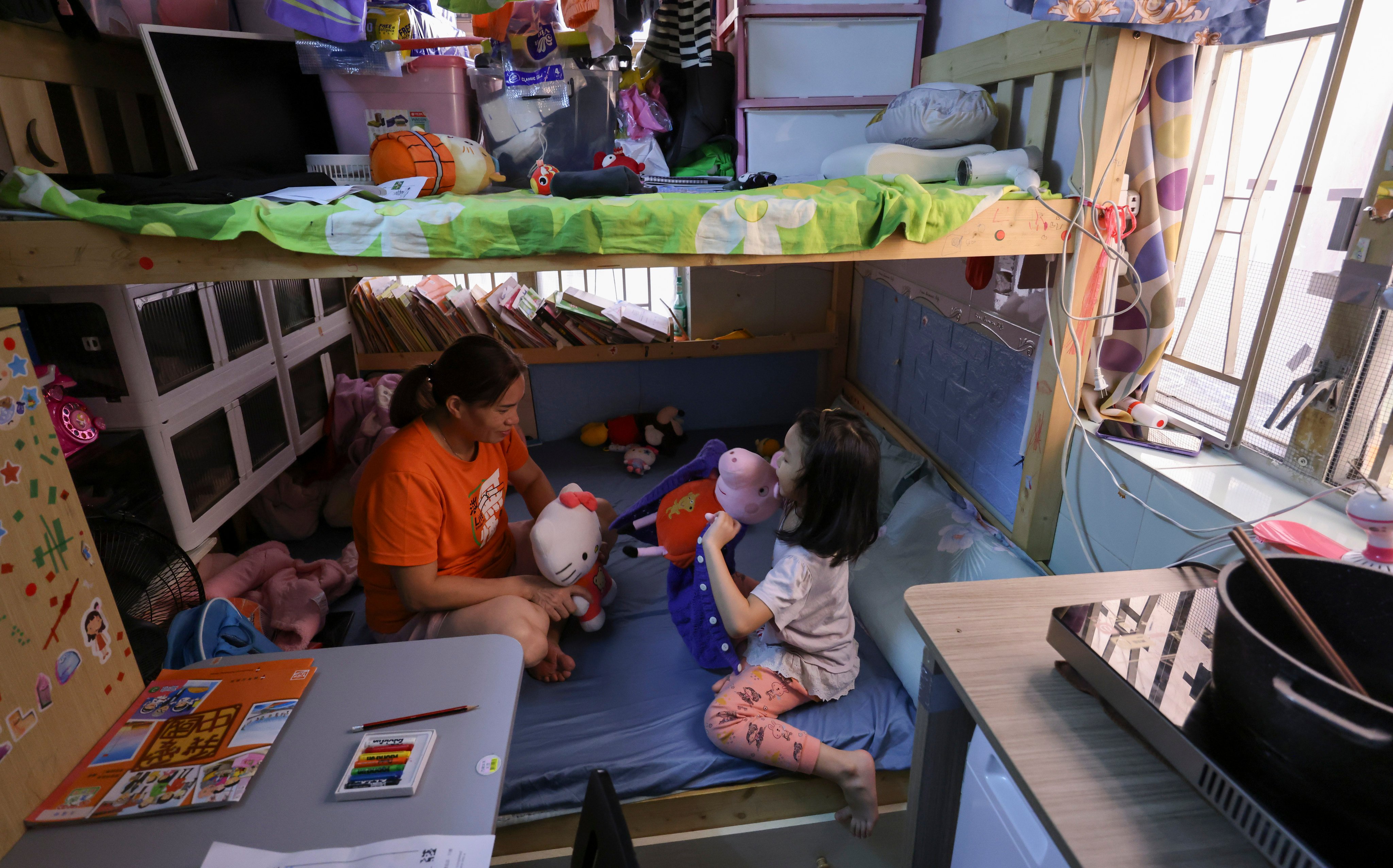 A mother and daughter in their subdivided flat in Sham Shui Po. Photo: May Tse