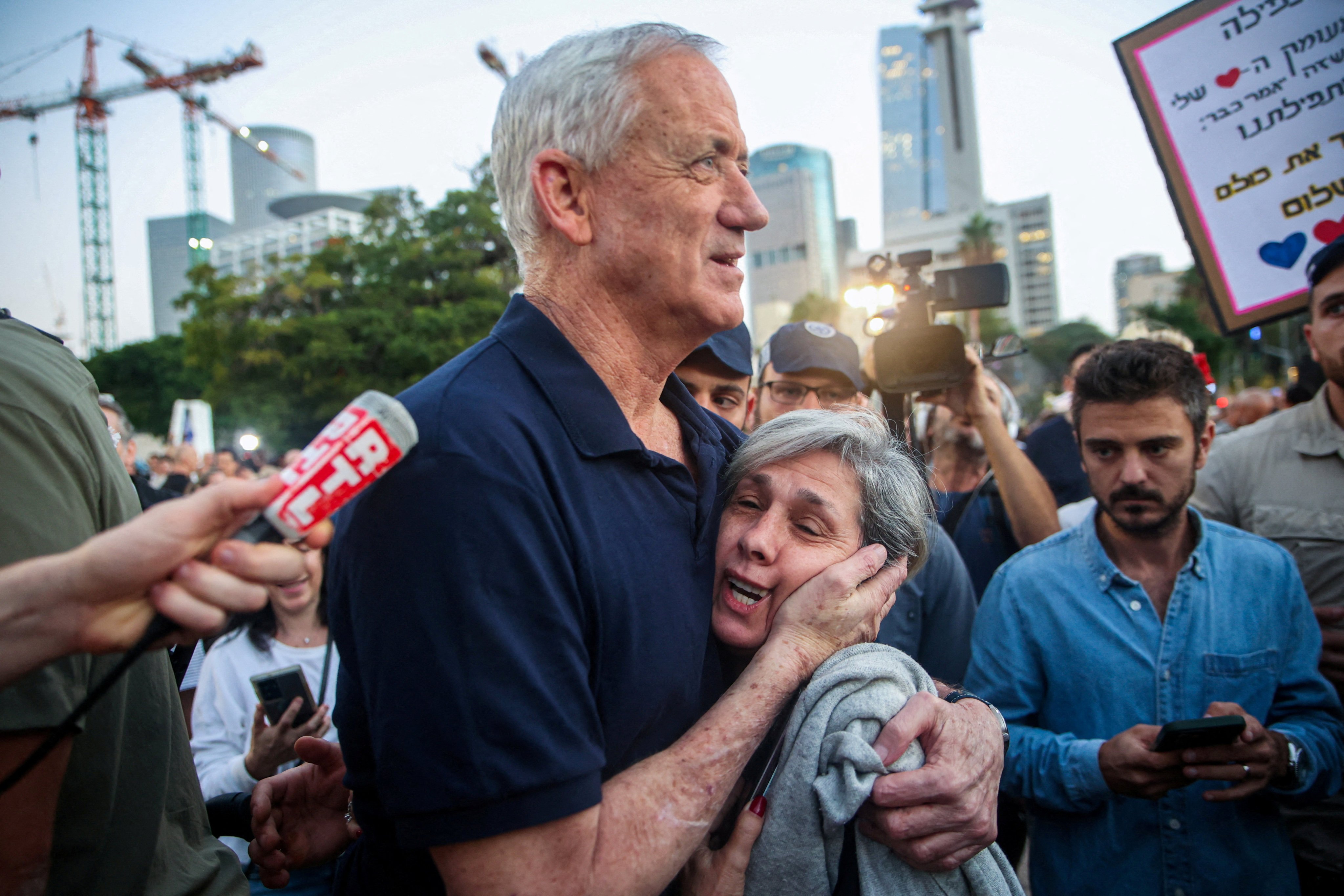 Israel war cabinet member Benny Gantz embraces a woman as he walks to meet with family members of hostages in Tel Aviv in November. Photo: Reuters