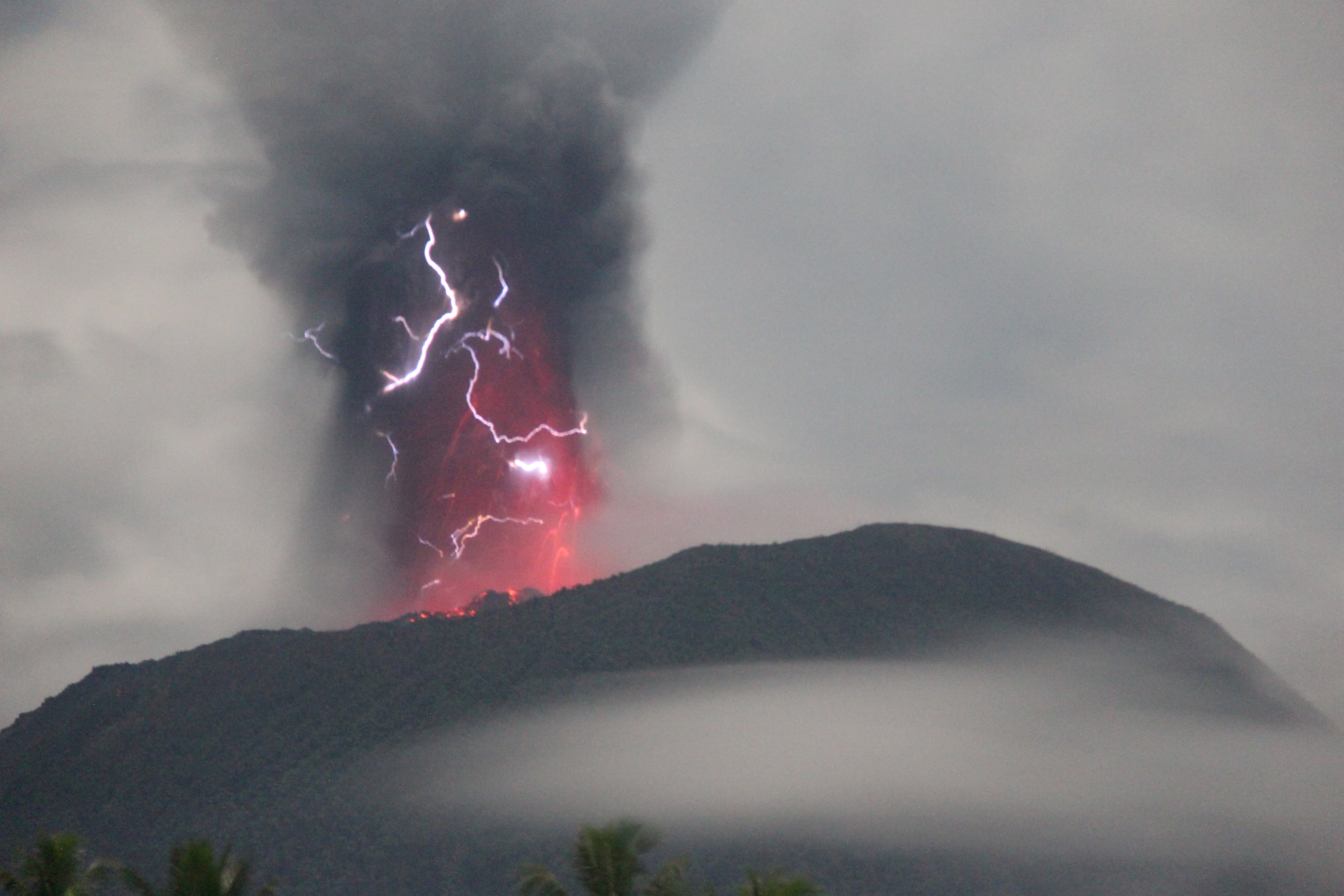 Lightning appears in a storm as Mount Ibu spews volcanic material during an eruption. Photo: Reuters