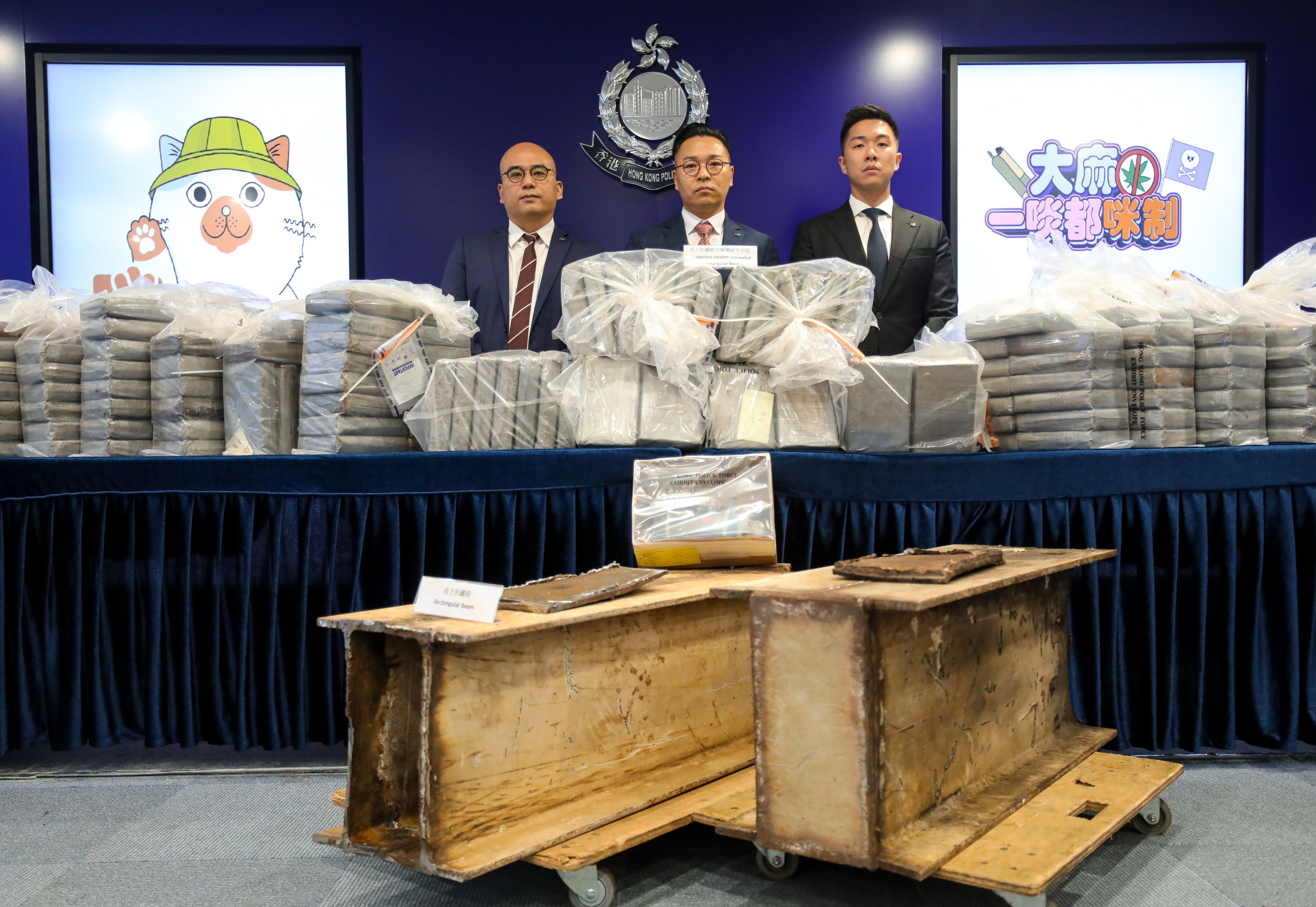 Police officers display the slabs of cocaine found hidden in scrap metal I-beams. Photo: Xiaomei Chen