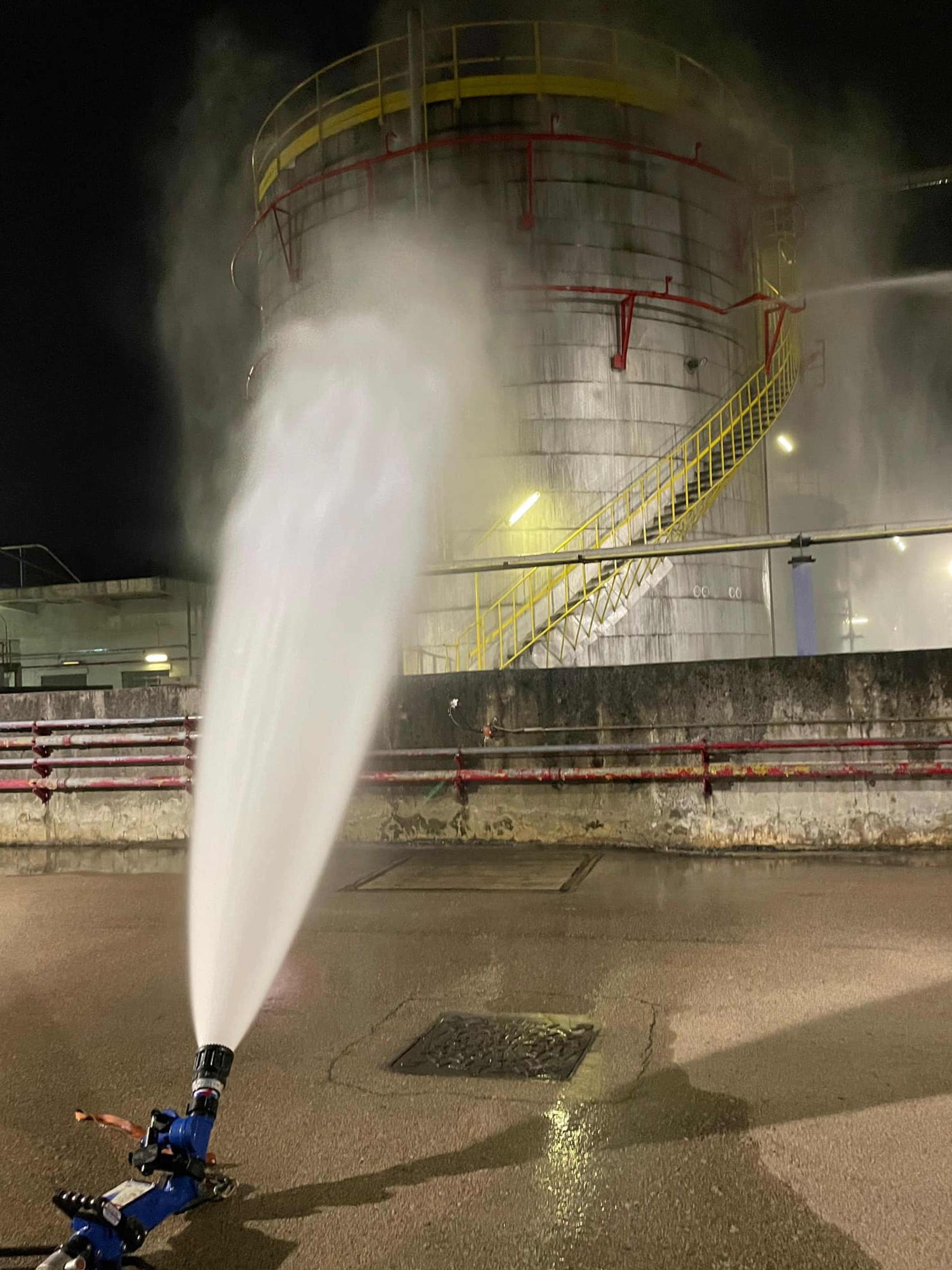 A remote-controlled jet of water douses a tank which leaked gas from toxic and flammable styrene in Kowloon in the early hours of Sunday. Photo: Facebook/FSD