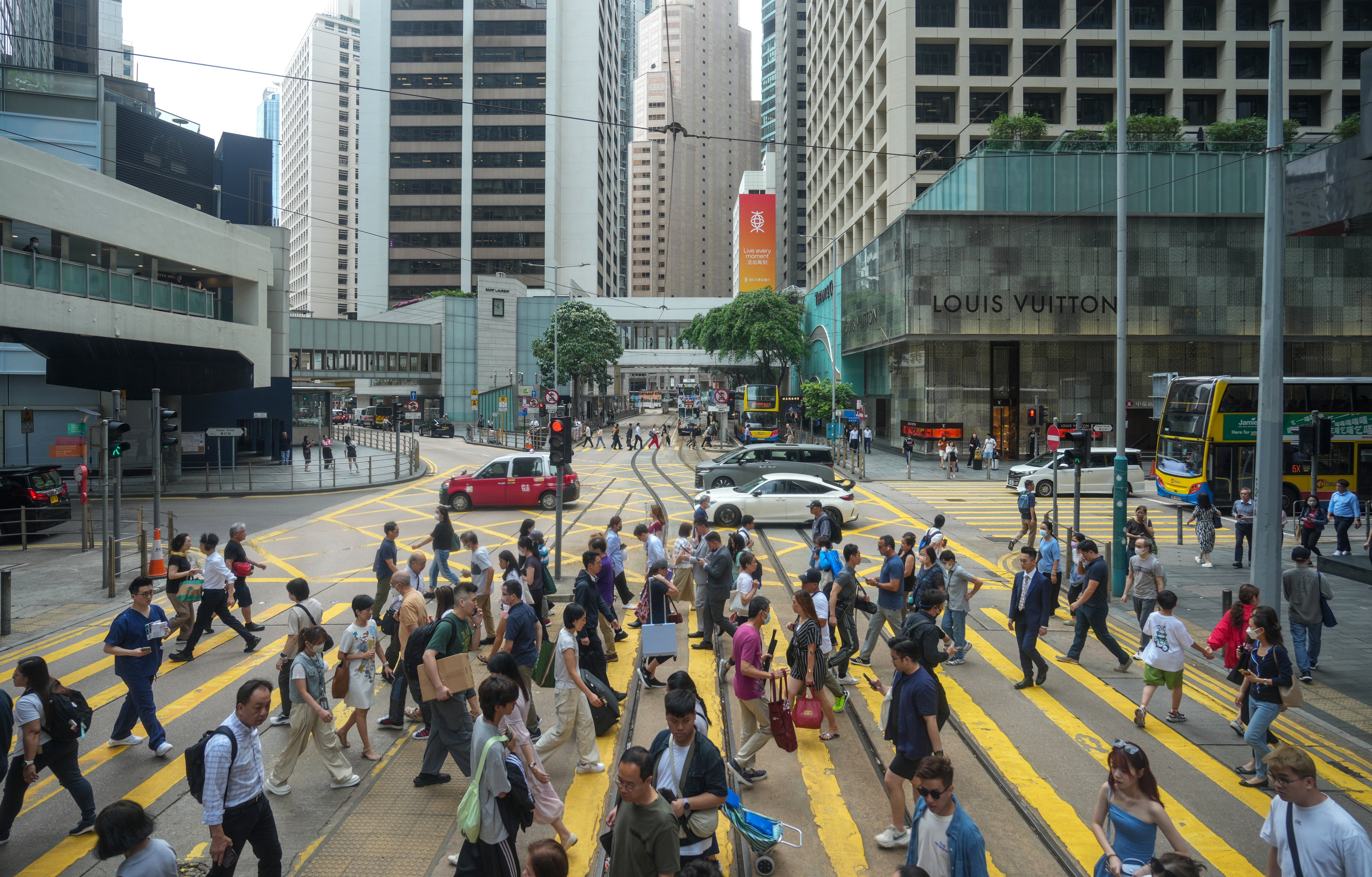 Pedestrians cross a road in Central, Hong Kong, on April 30, 2024. The city’s financial-services sector is a strong adopter of AI technology. Photo: Sam Tsang