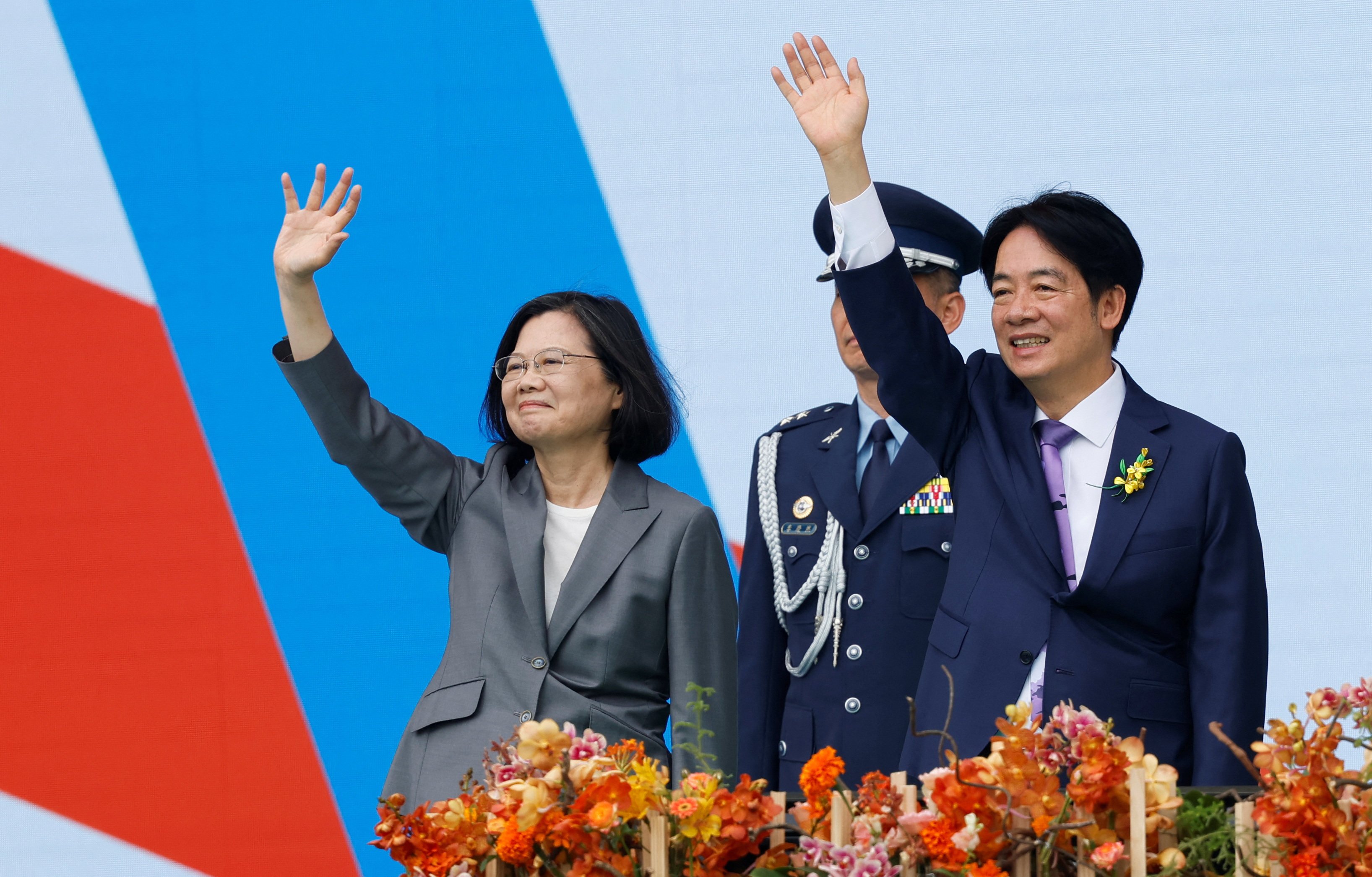 Taiwan’s former president Tsai Ing-wen and new President William Lai Ching-te wave during the inauguration ceremony outside the presidential office building in Taipei on Monday, May 20. Photo: Reuters