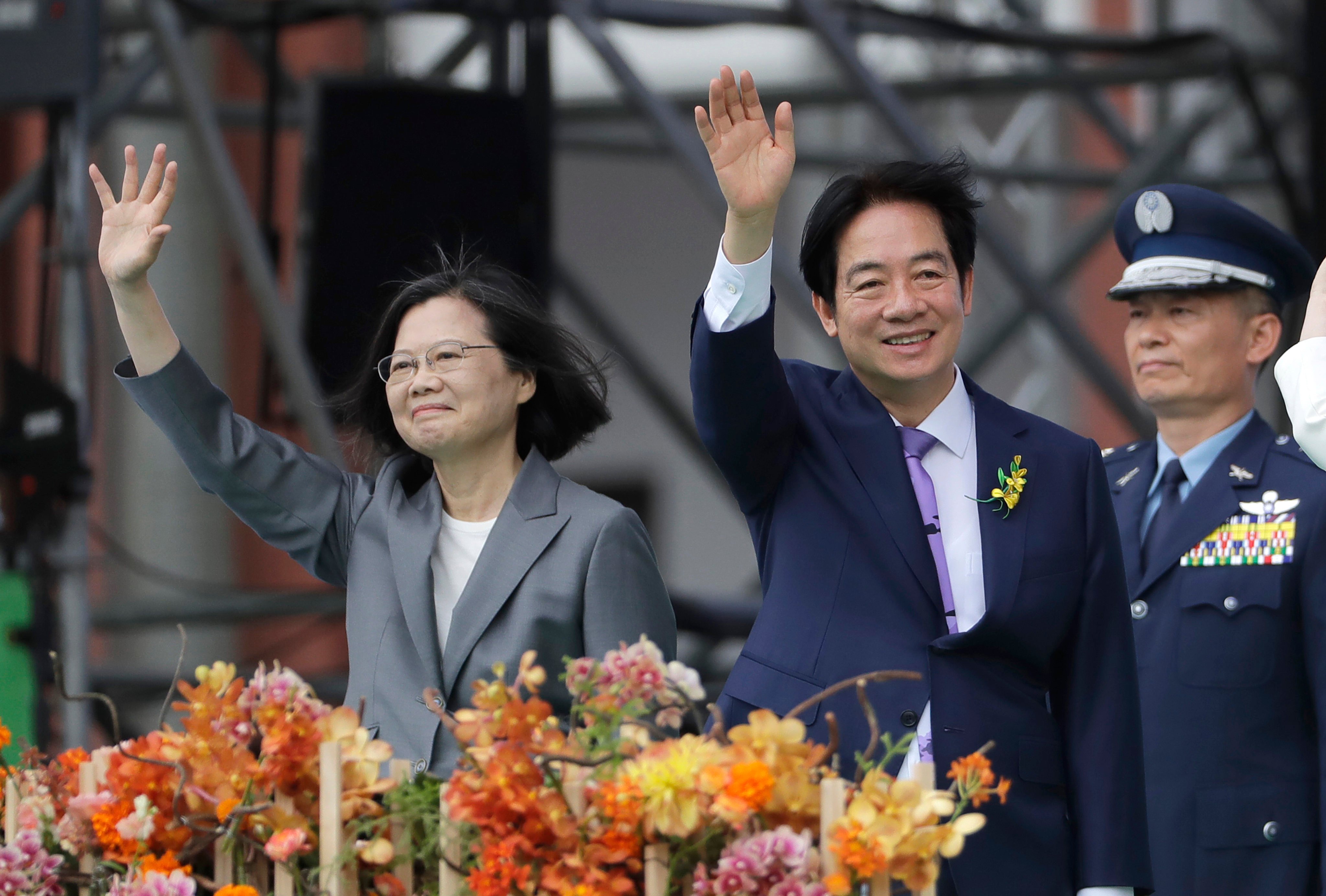 Taiwan’s new leader William Lai (right) and former president Tsai Ing-wen wave during the inauguration ceremony in Taipei on Monday. Photo: AP