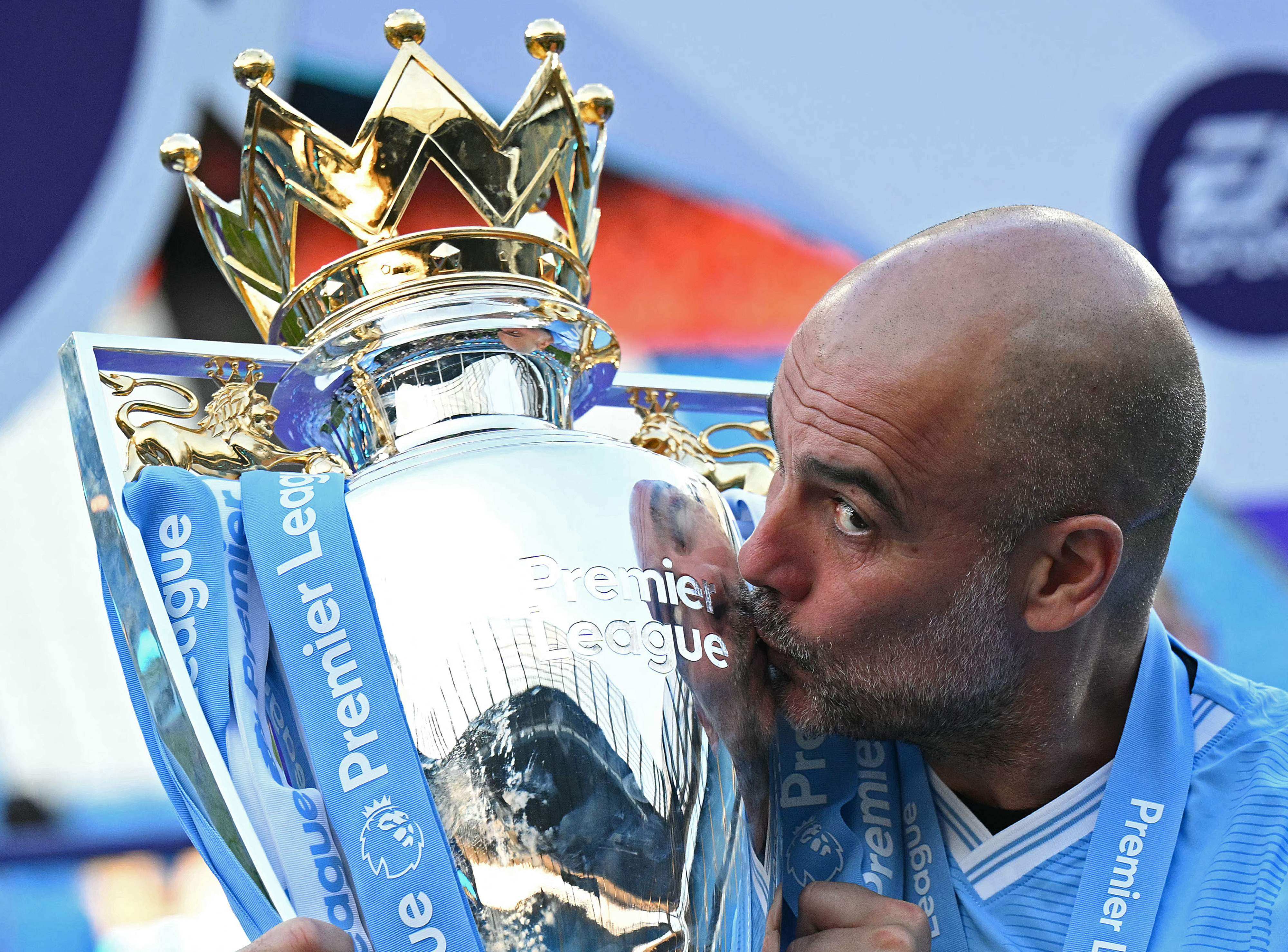 Manchester City’s Spanish manager Pep Guardiola kisses the Premier League trophy after his side’s 3-1 win over Ham United at the Etihad Stadium. Photo: AFP