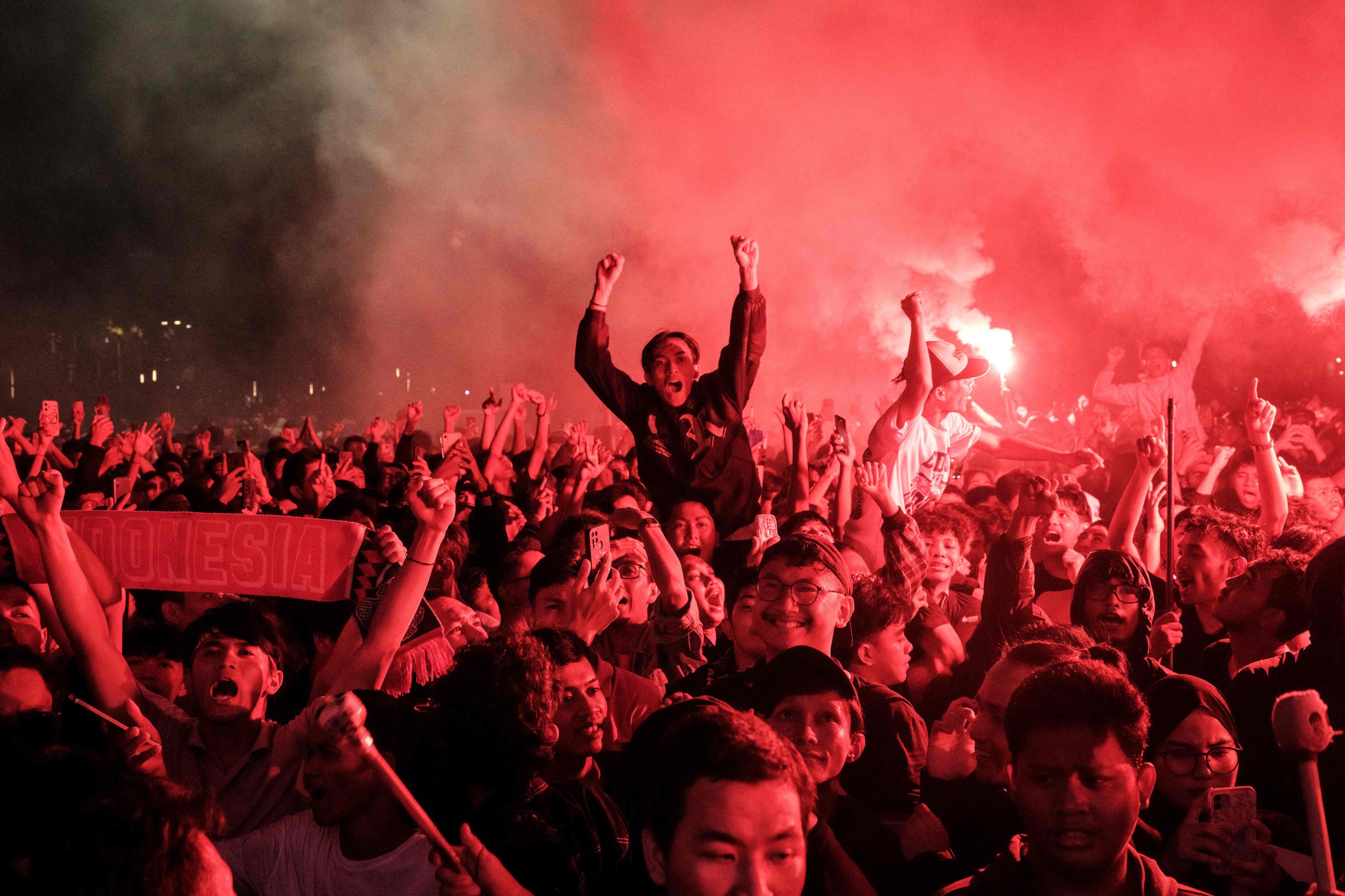 The passion of Indonesia’s football fans, seen here outside the Gelora Bung Karno stadium watching the live stream of the pre-Olympic playoff, probably outstrips any country on the Asian continental mainland. Photo: AFP