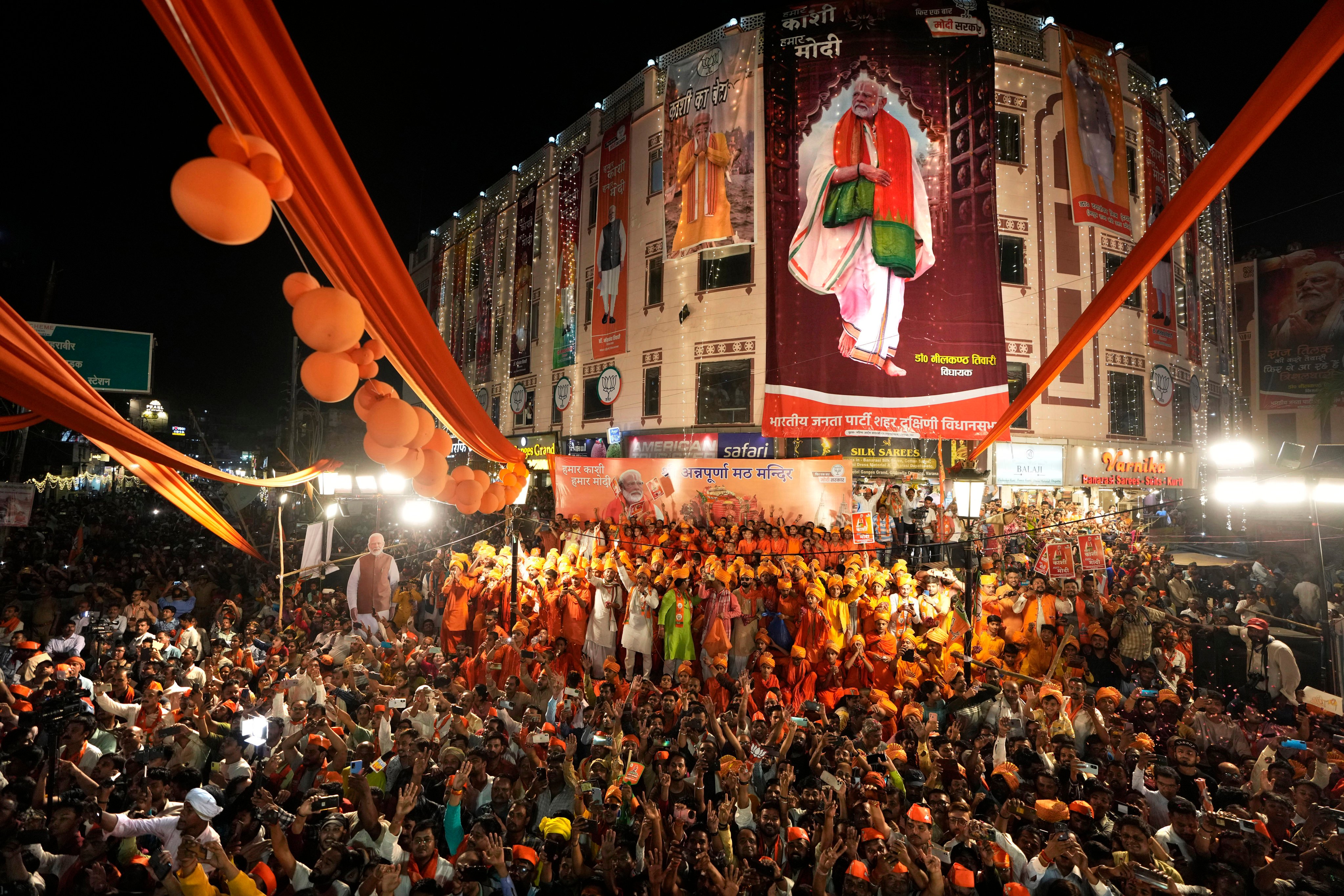 Supporters of the ruling Bharatiya Janata Party gather to greet Indian Prime Minister Narendra Modi during a campaign roadshow for the elections in Varanasi, India, on May 13. Photo: AP