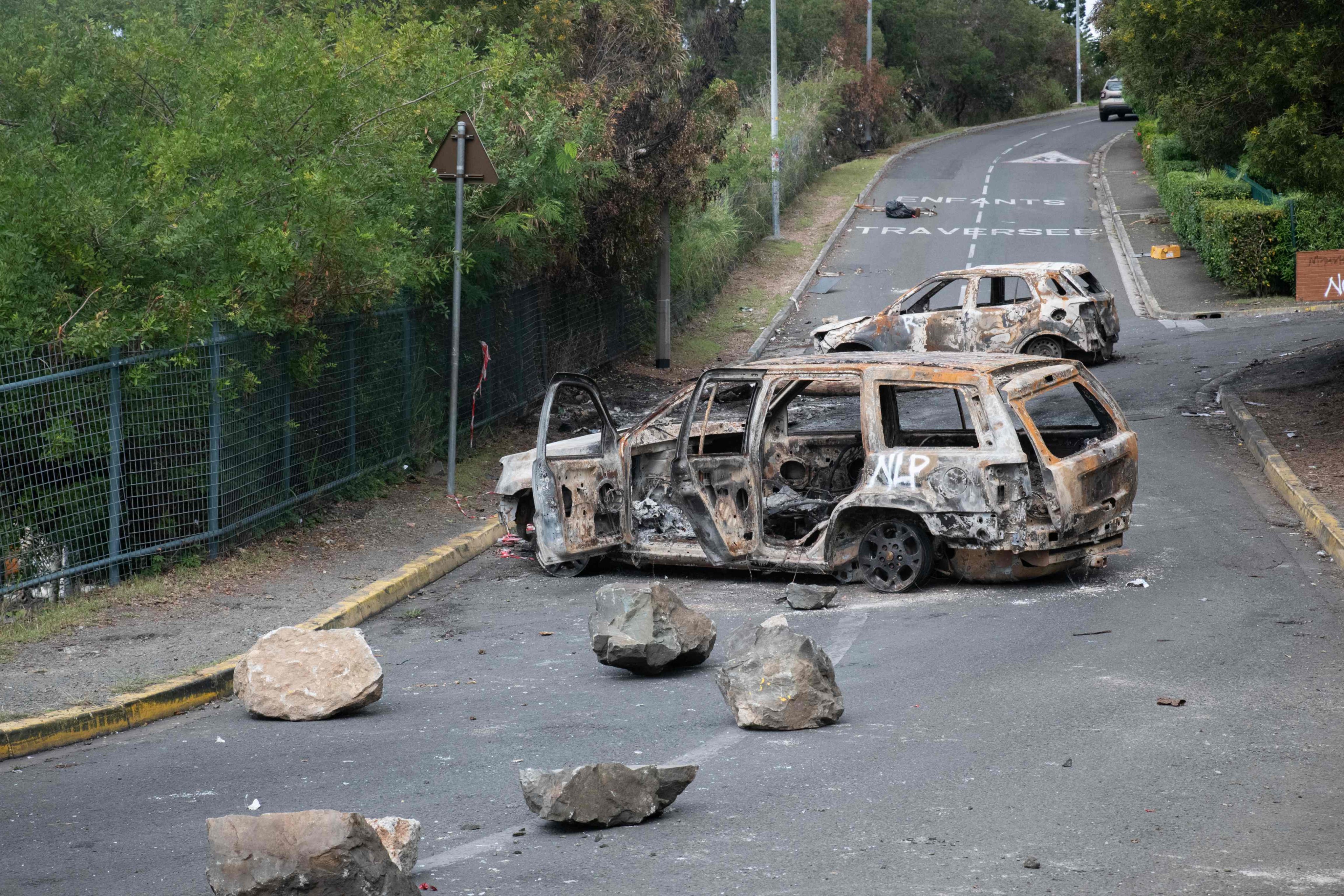 Burnt vehicles in the Magenta district of Noumea, France’s Pacific territory of New Caledonia, on Tuesday Photo: AFP