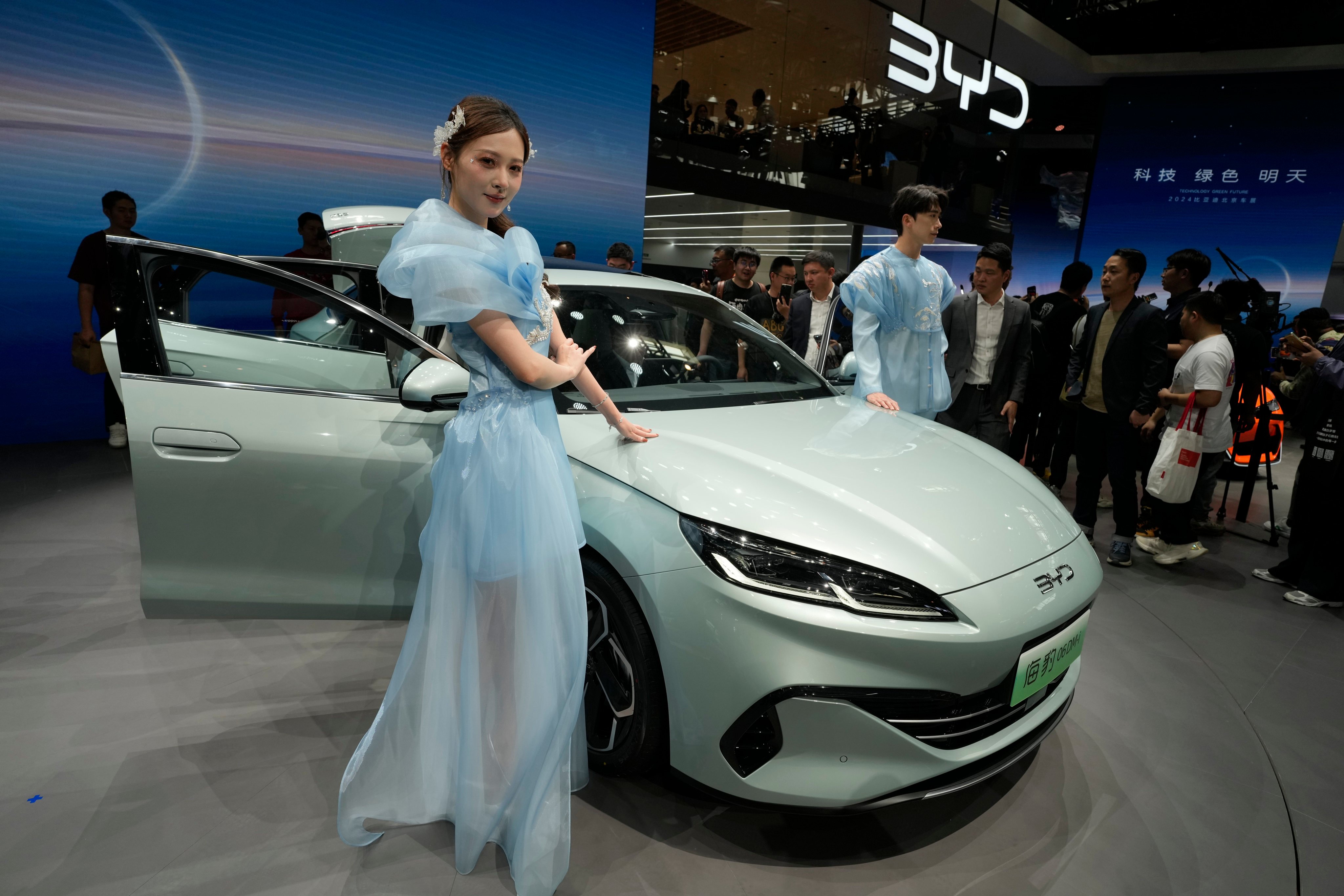 Models pose near the BYD Seal 06 Dmi unveiled during Auto China 2024 held in Beijing, Thursday, April 25, 2024. BYD gained on Wednesday after rival Xpeng’s first quarter earnings beat estimates. Photo:AP