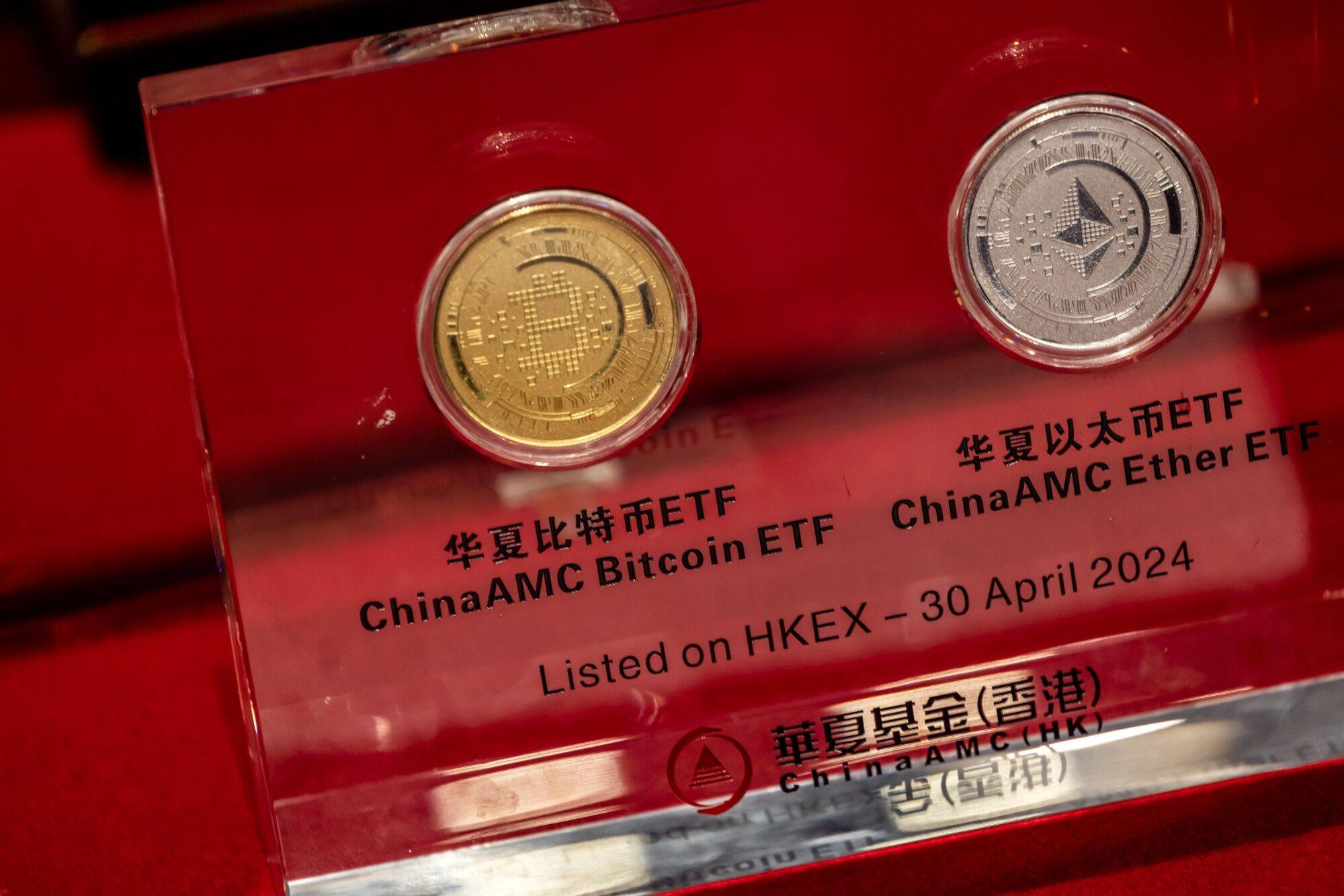 Illustrative bitcoin and ether tokens presented during the listing ceremony of the spot cryptocurrency ETFs issued by China Asset Management at the Hong Kong stock exchange on April 30, 2024. Photo: Bloomberg