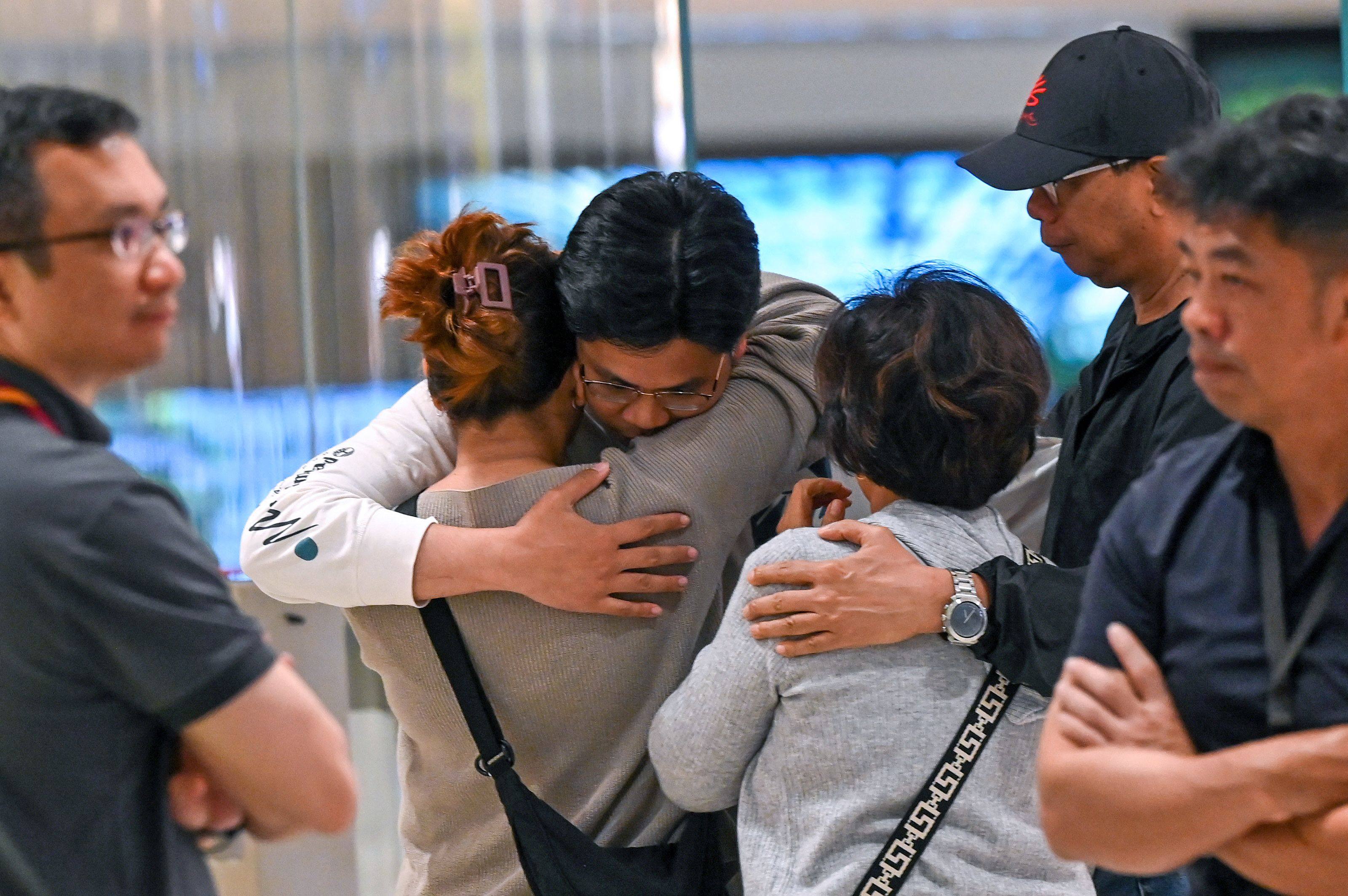 Passengers of the turbulence-hit Singapore Airlines flight greet family members upon arrival at Changi Airport in the city state on May 22. Photo: AFP
