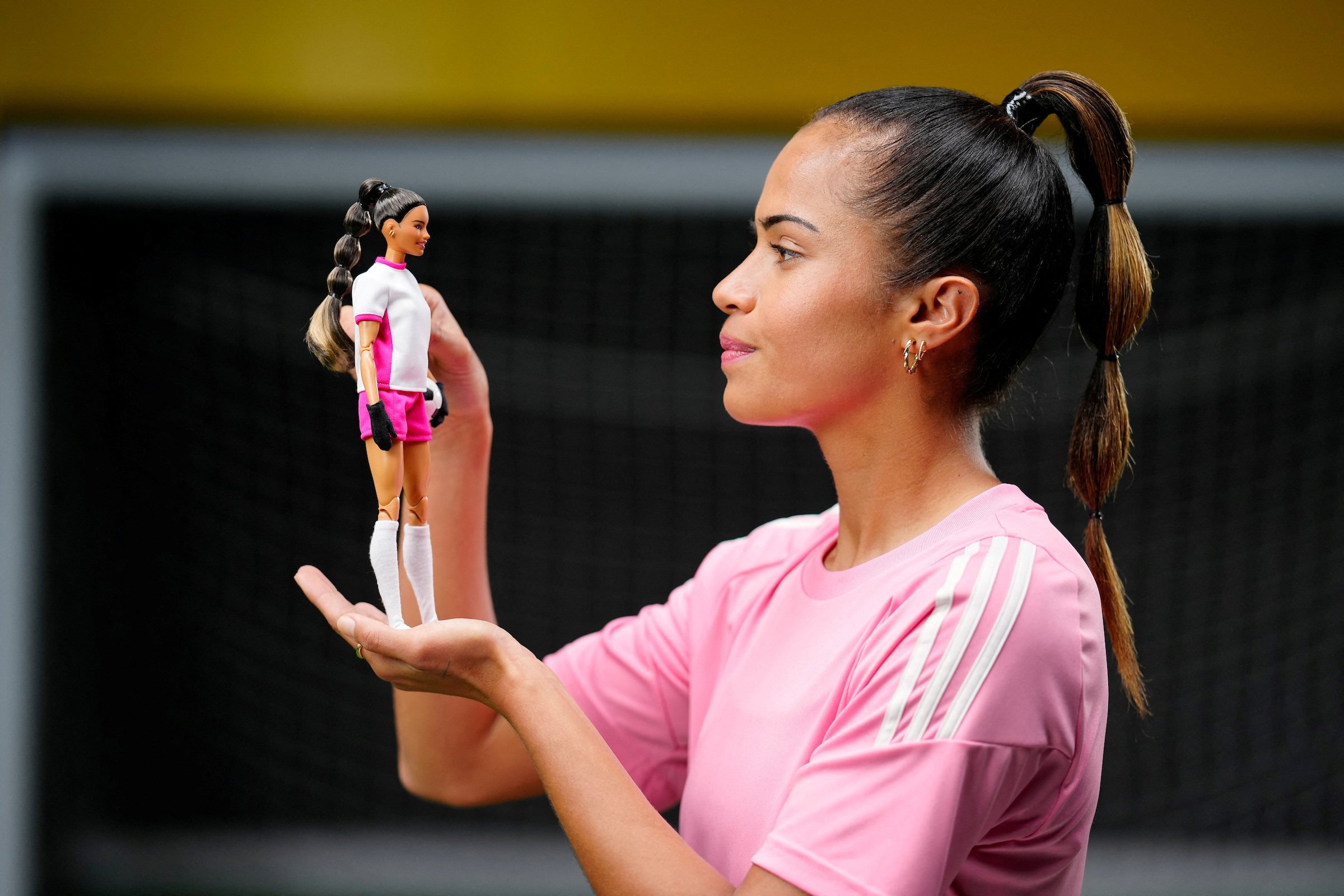 Australian and Manchester City footballer Mary Fowler, poses with her Barbie doll, which wears gloves and holds a football. Photo: Reuters