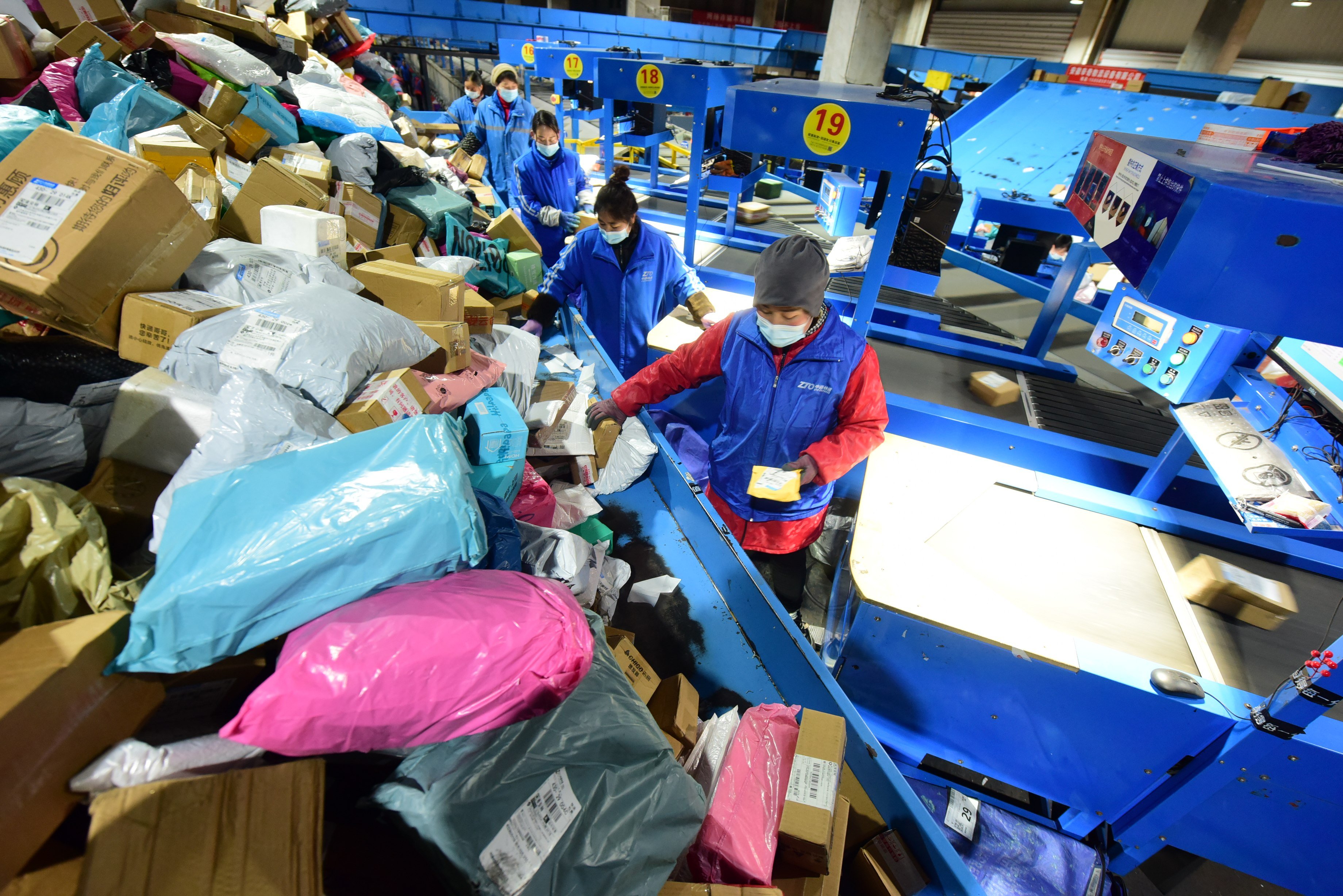 Workers are sorting parcels at an e-commerce logistics park in Lianyungang, China’s Jiangsu province. Photo: NurPhoto via Getty Images