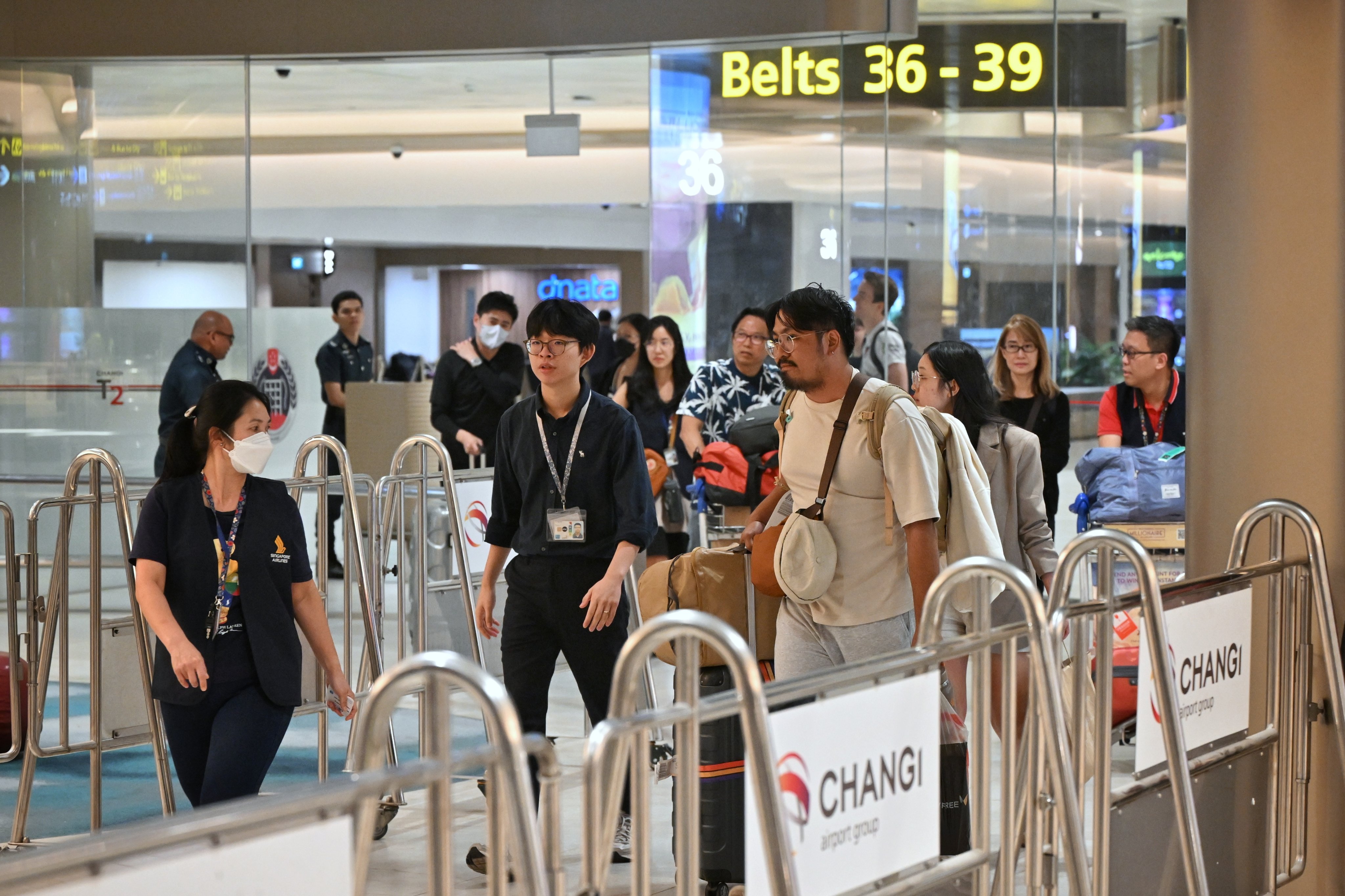 Passengers of Singapore Airlines flight SQ321 arrive at Changi Airport in Singapore on Wednesday. Photo: EPA-EFE