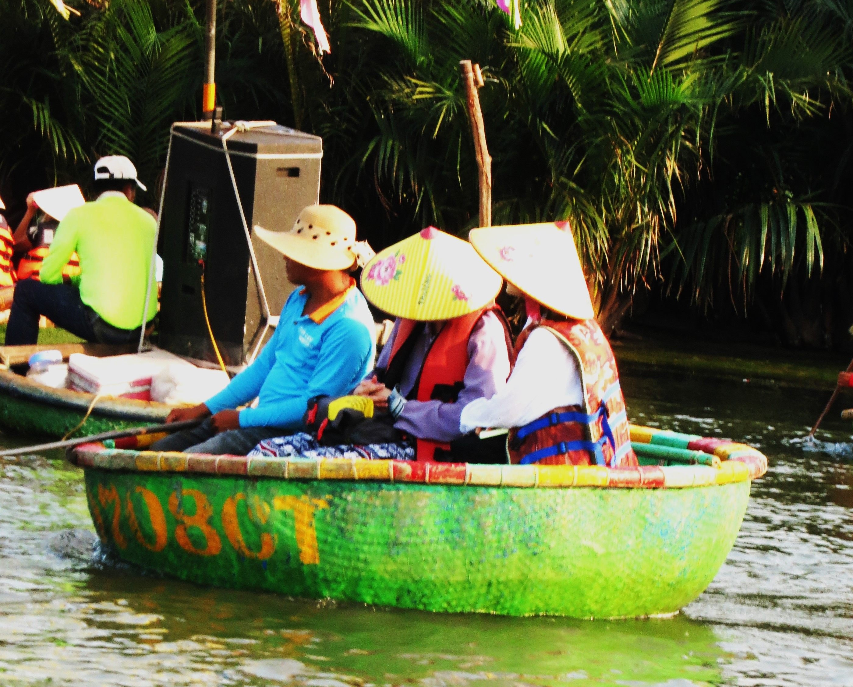 Tourists on traditional basket boats on the Thu Bon river blast music from a mobile sound system. Photo: Tom Fawthrop 