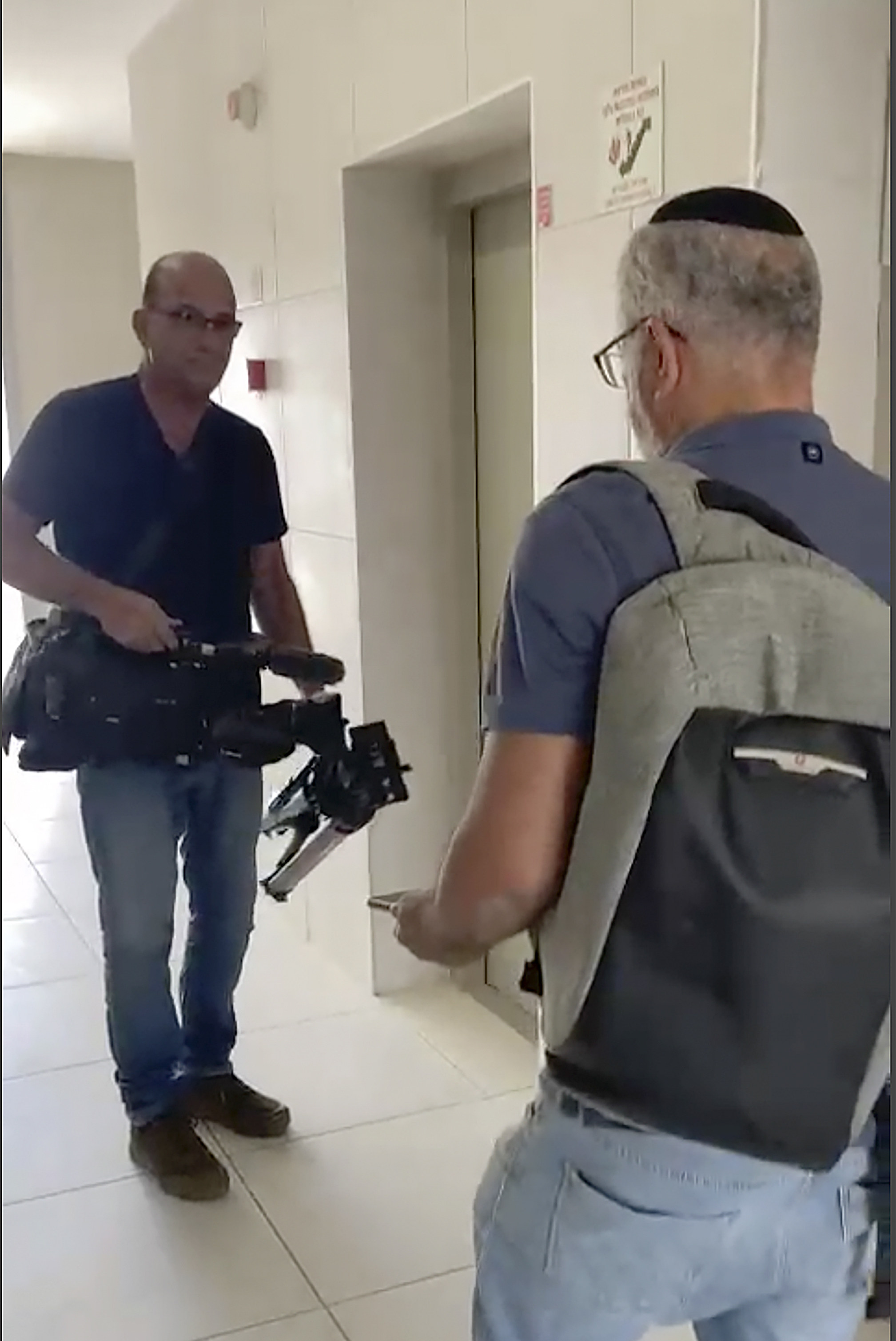 In this image from video, Israeli officials seize AP video equipment from an apartment block in Sderot, Southern Israel, on Tuesday. Photo: AP