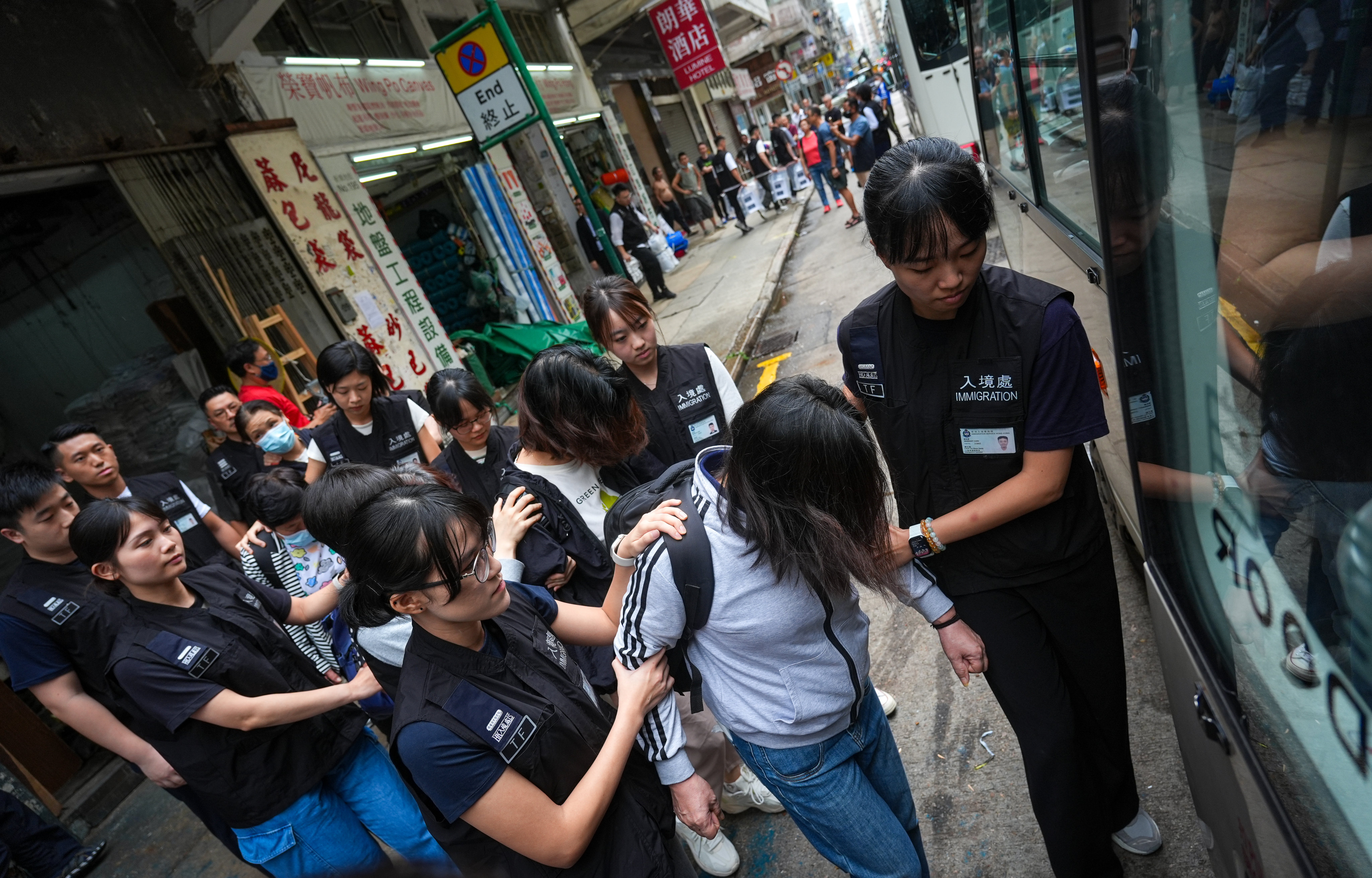 Hong Kong immigration officers arrest 15 illegal workers from mainland China in Yau Ma Tei. Photo: Eugene Lee
