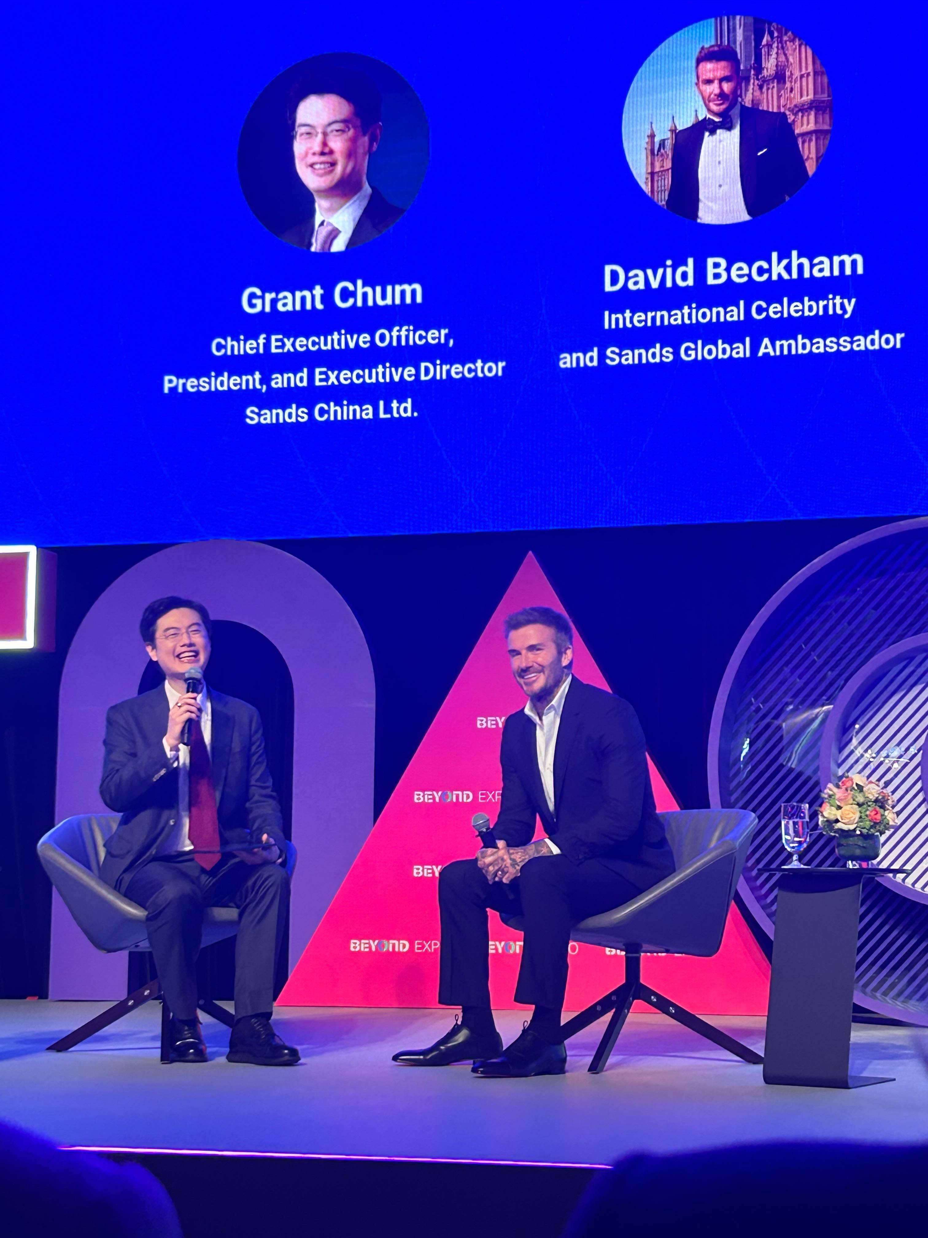 Grant Chum, CEO of Sands China, and former England football captain David Beckham speak at the Macau expo on May 23. Photo: Mia Castagnone