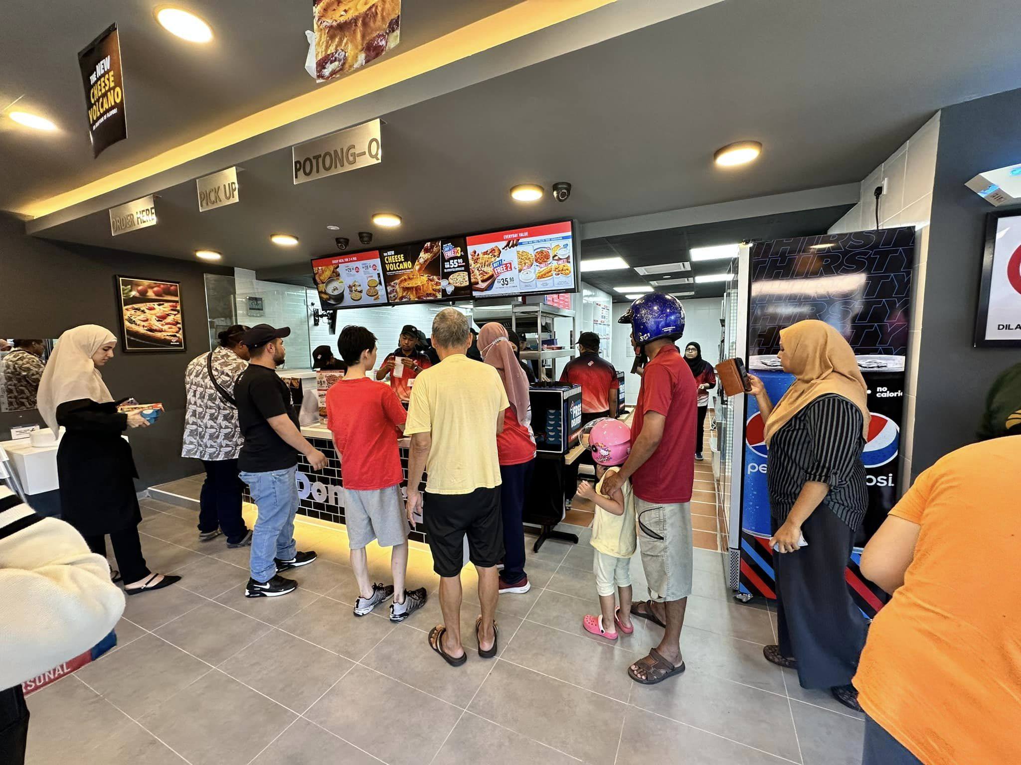 Customers at a Domino’s Pizza outlet in Malaysia. Photo: Facebook/DominosMY