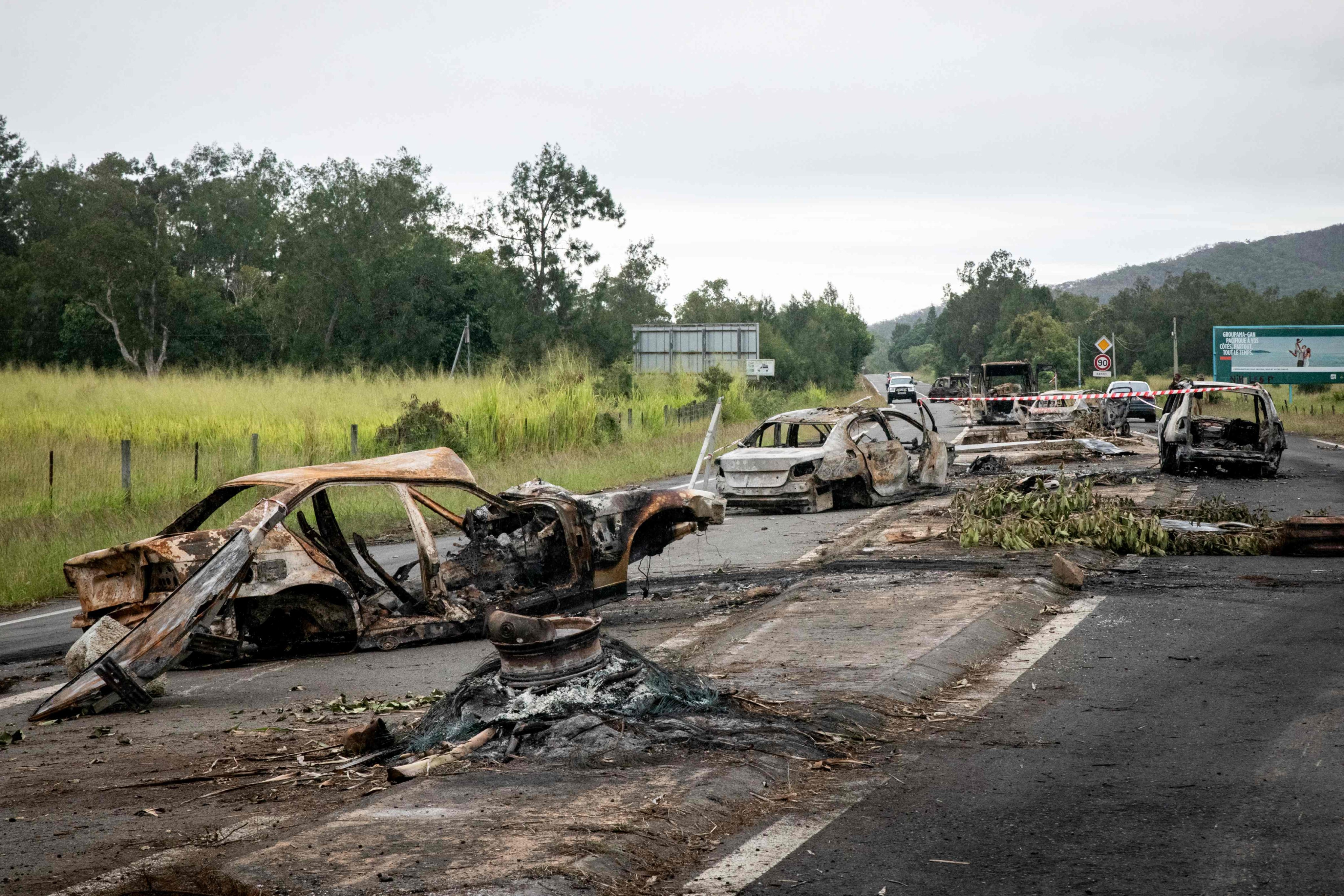 Burnt vehicles can be seen at a roadblock in the capital of the French Pacific territory of New Caledonia, which has been rocked by riots after France’s National Assembly approved contentious voting reforms to the territory that angered independence supporters. Photo: AFP/dpa