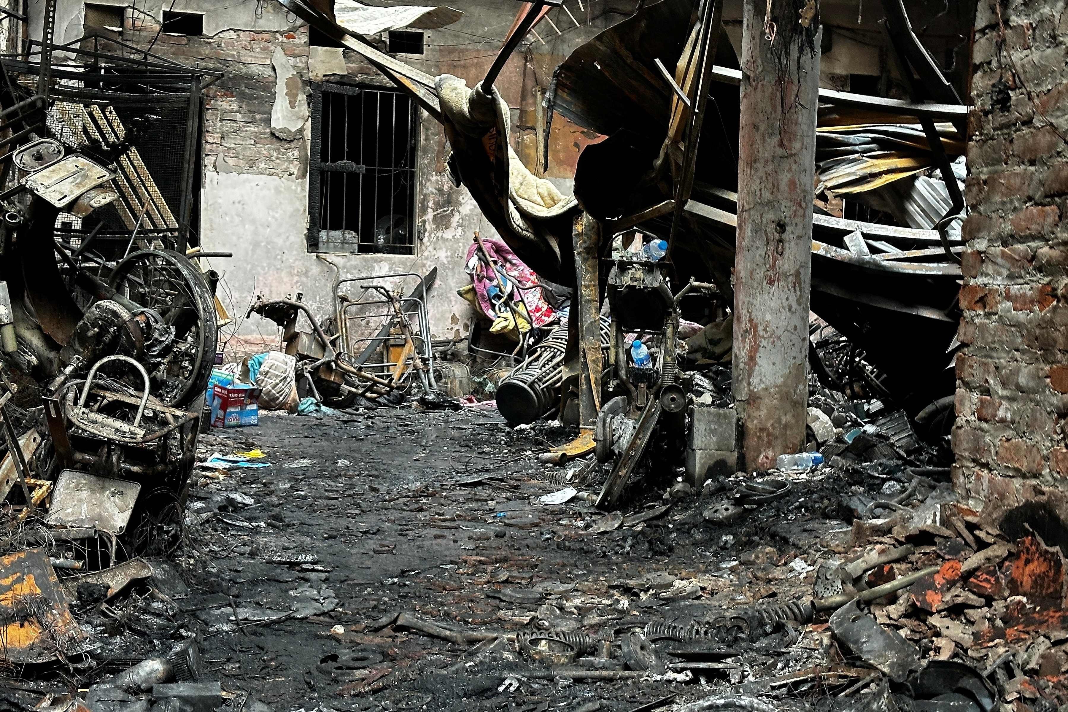 Charred belongings are seen outside a burnt house following a large fire at a residential building complex in Hanoi on Friday. Photo: AFP