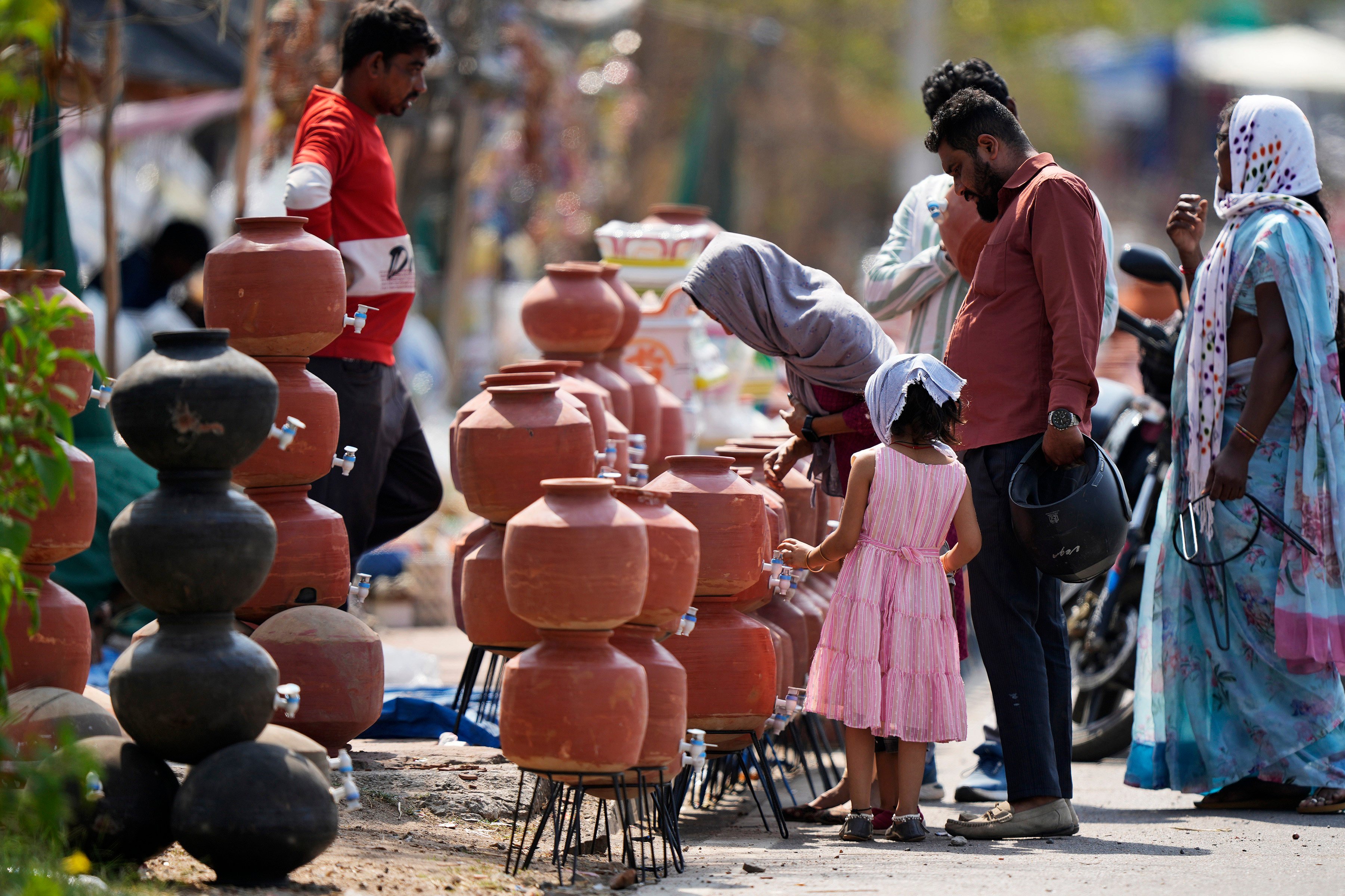 People shop for earthen water vessels, known locally as poor man’s refrigerator, from a roadside vendor in Hyderabad, India, on May 2. Photo: AP
