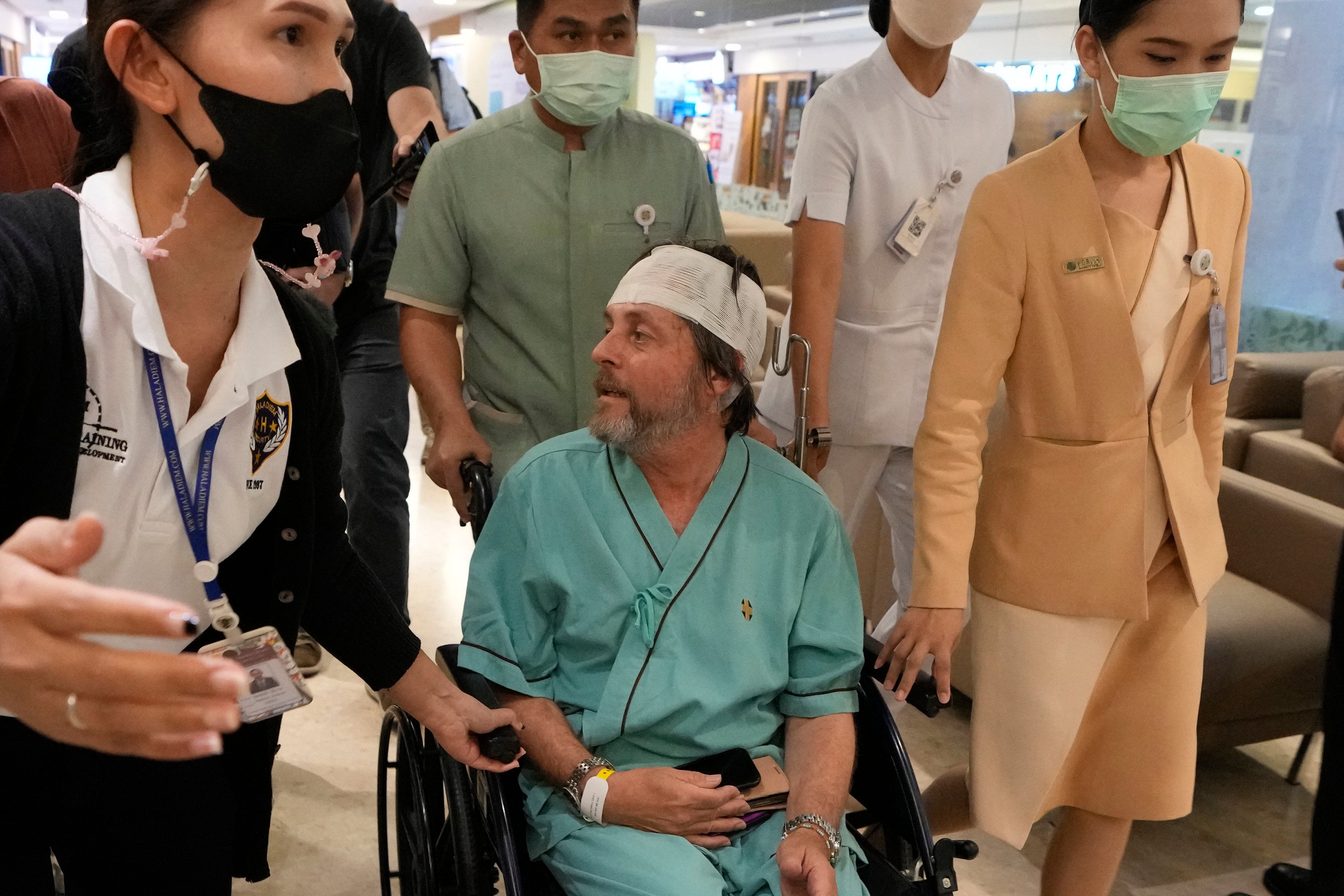 An Australian passenger, who was injured on a flight that was battered by severe turbulence, talks to reporters at Samitivej Srinakarin Hospital in Bangkok, Thailand on Thursday. Photo: AP