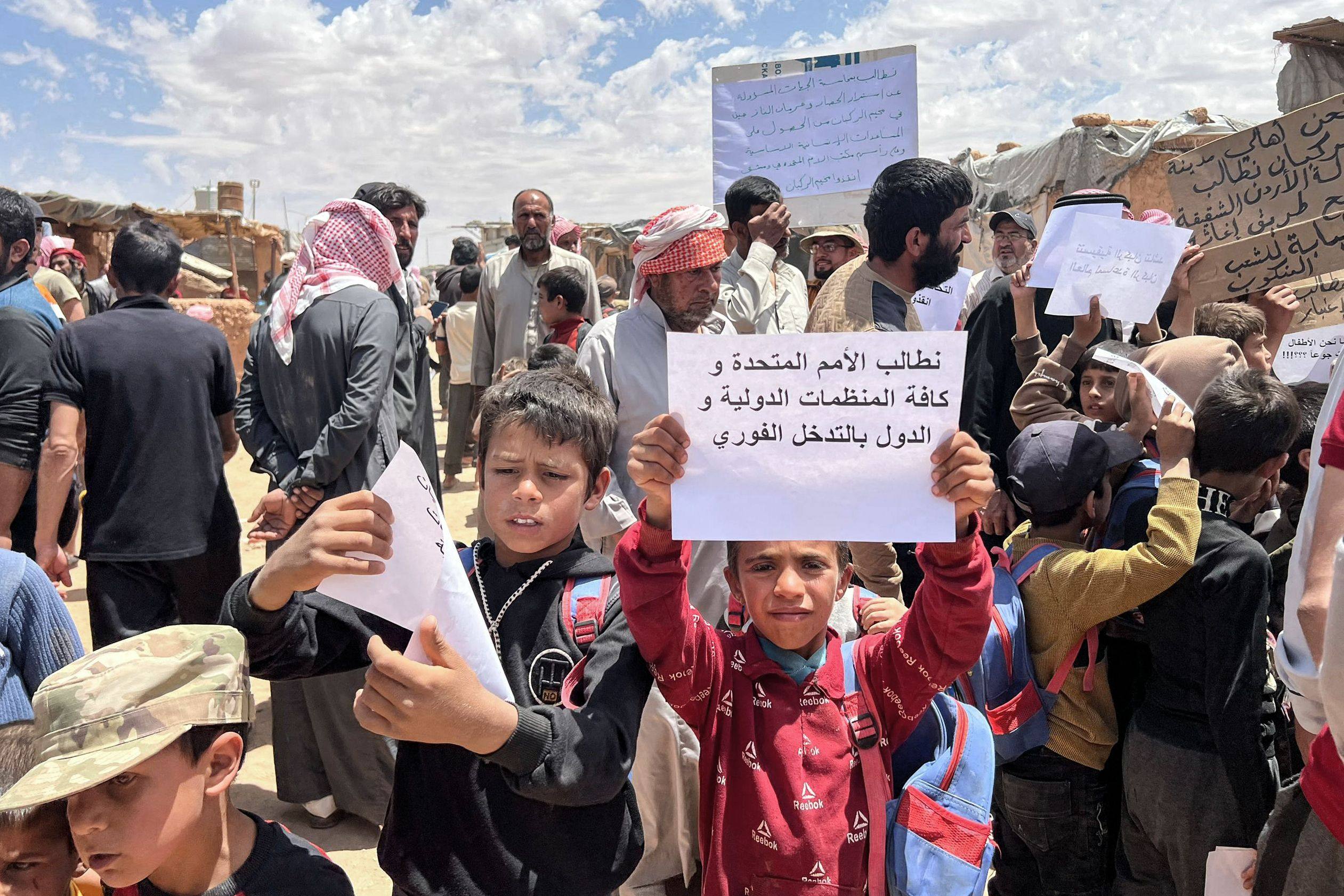 Displaced Syrian children ask for international intervention to help ease their situation at the Rukban camp in southern Syria at the border with Iraq and Jordan. Photo: AFP