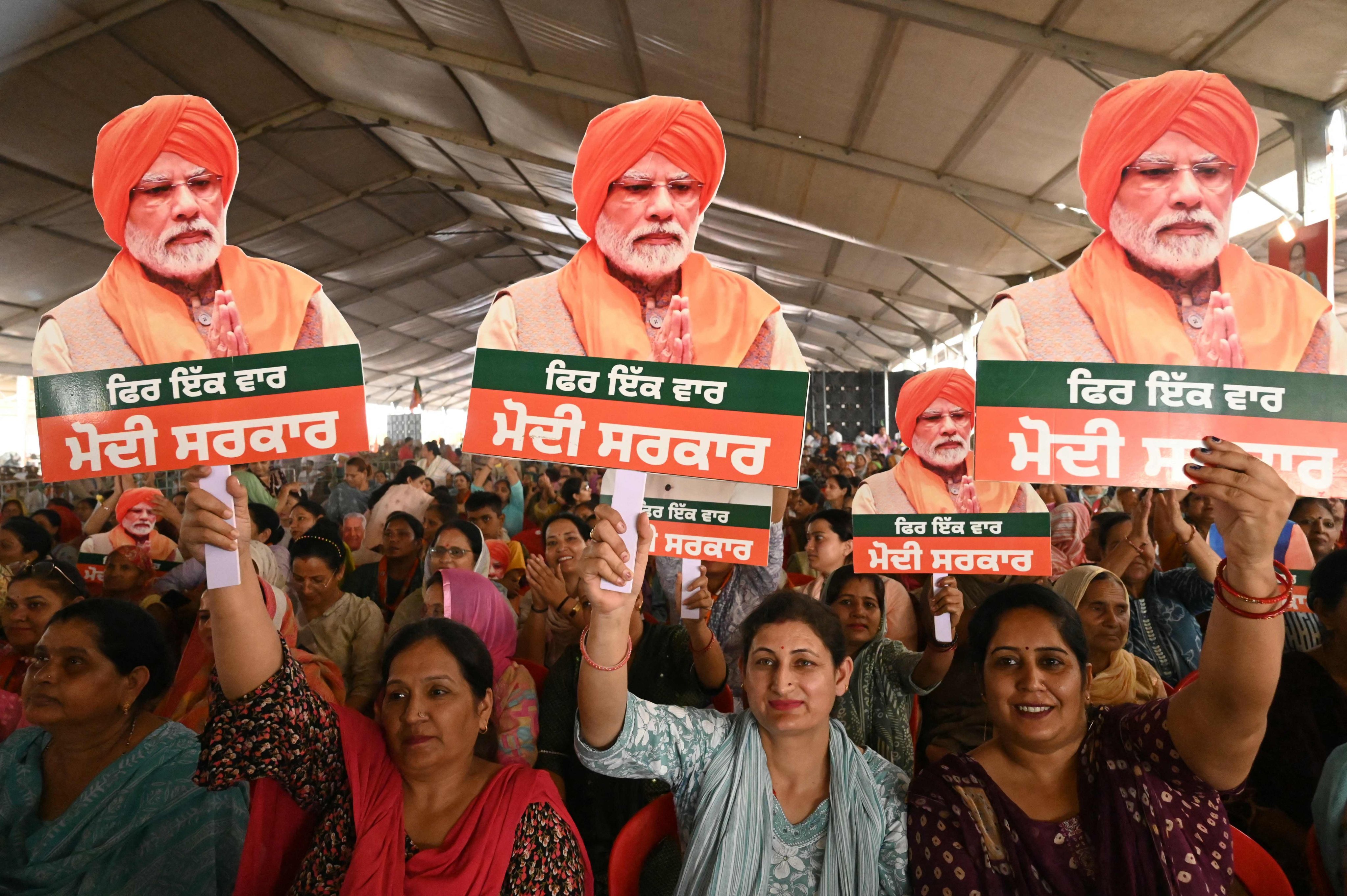 Supporters hold cut-outs of India’s Prime Minister and leader of the ruling Bharatiya Janata Party (BJP) Narendra Modi during an election campaign rally in Gurdaspur. Photo: AFP