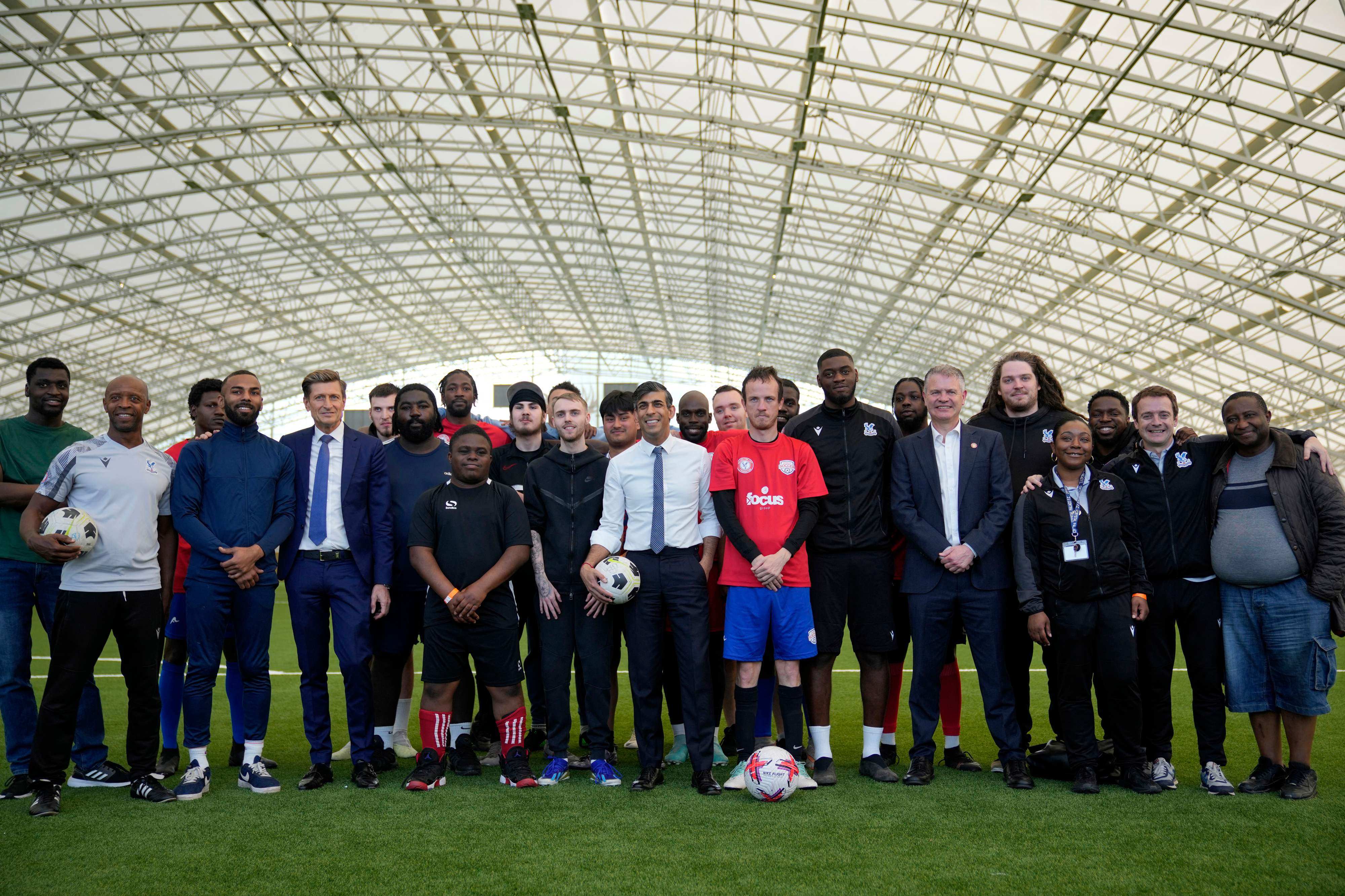 Sunak (centre), seen on a visit to a non-profit organisation, has opted for an election days after England’s probable first knockout match. Photo: AFP