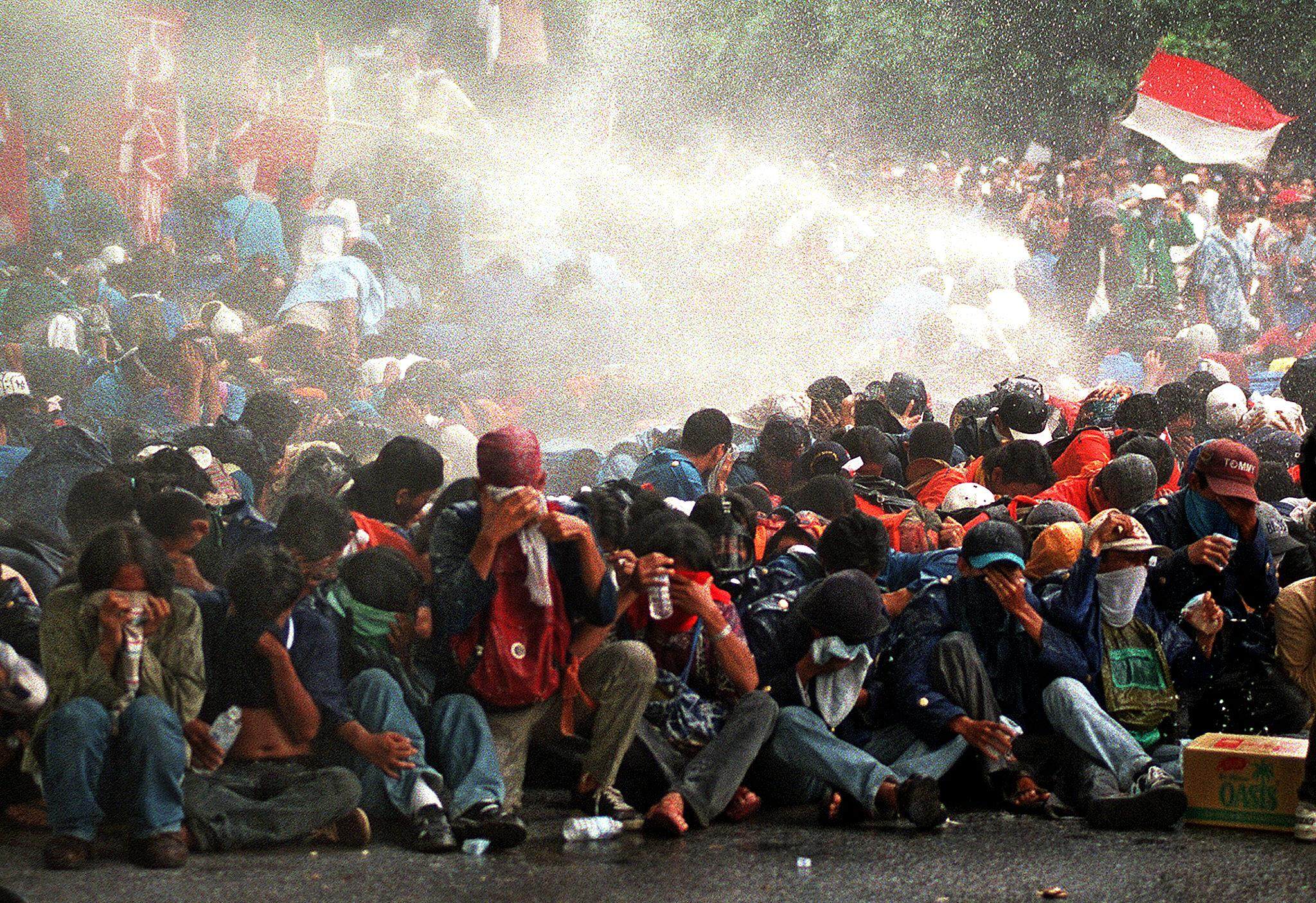 Indonesian security forces fire a water cannon at university students during a protest in Jakarta in November 1998. Photo: AFP