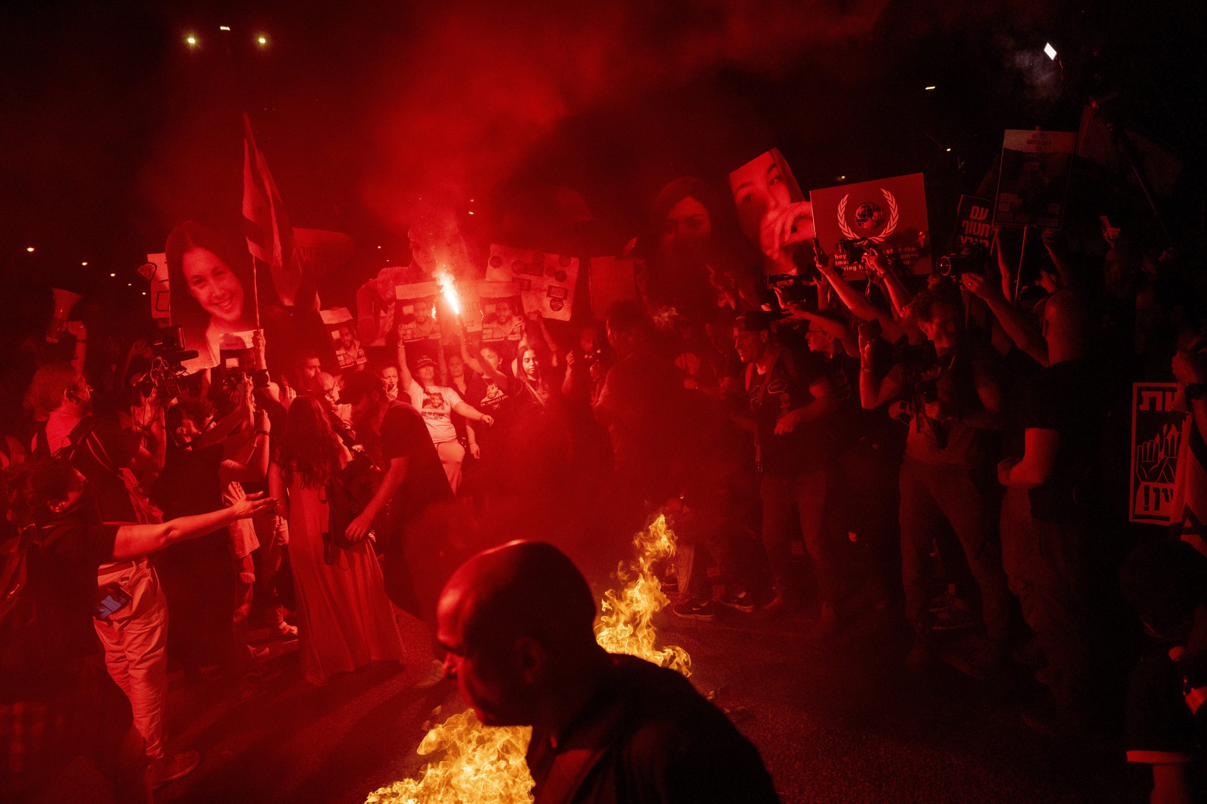 Demonstrators burn fire during a protest against Israeli Prime Minister Benjamin Netanyahu’s government in Tel Aviv on Sunday. Photo: AP