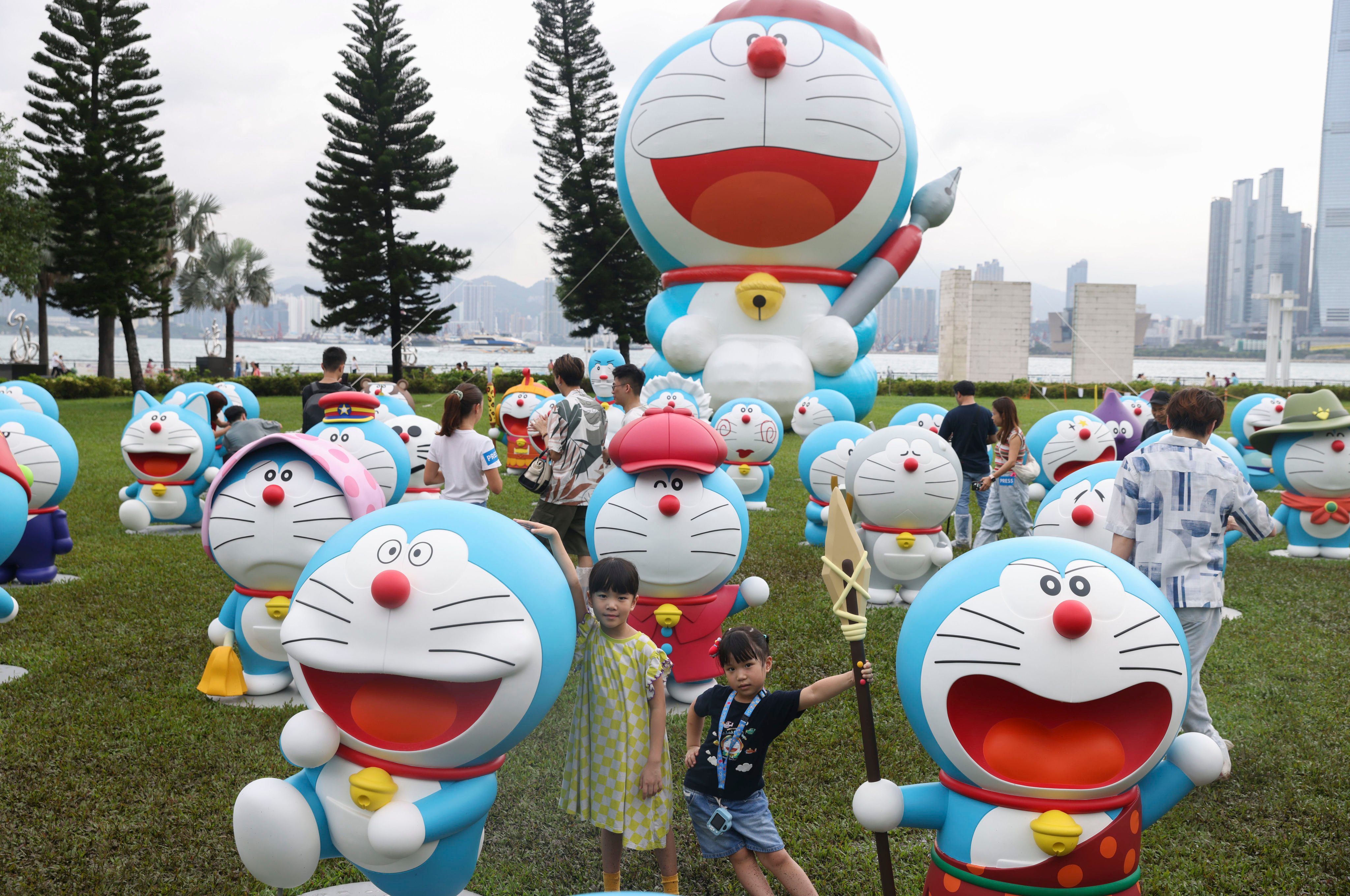 Children pose for a photo with Doraemon in Sai Ying Pun. Photo: Yik Yeung-man