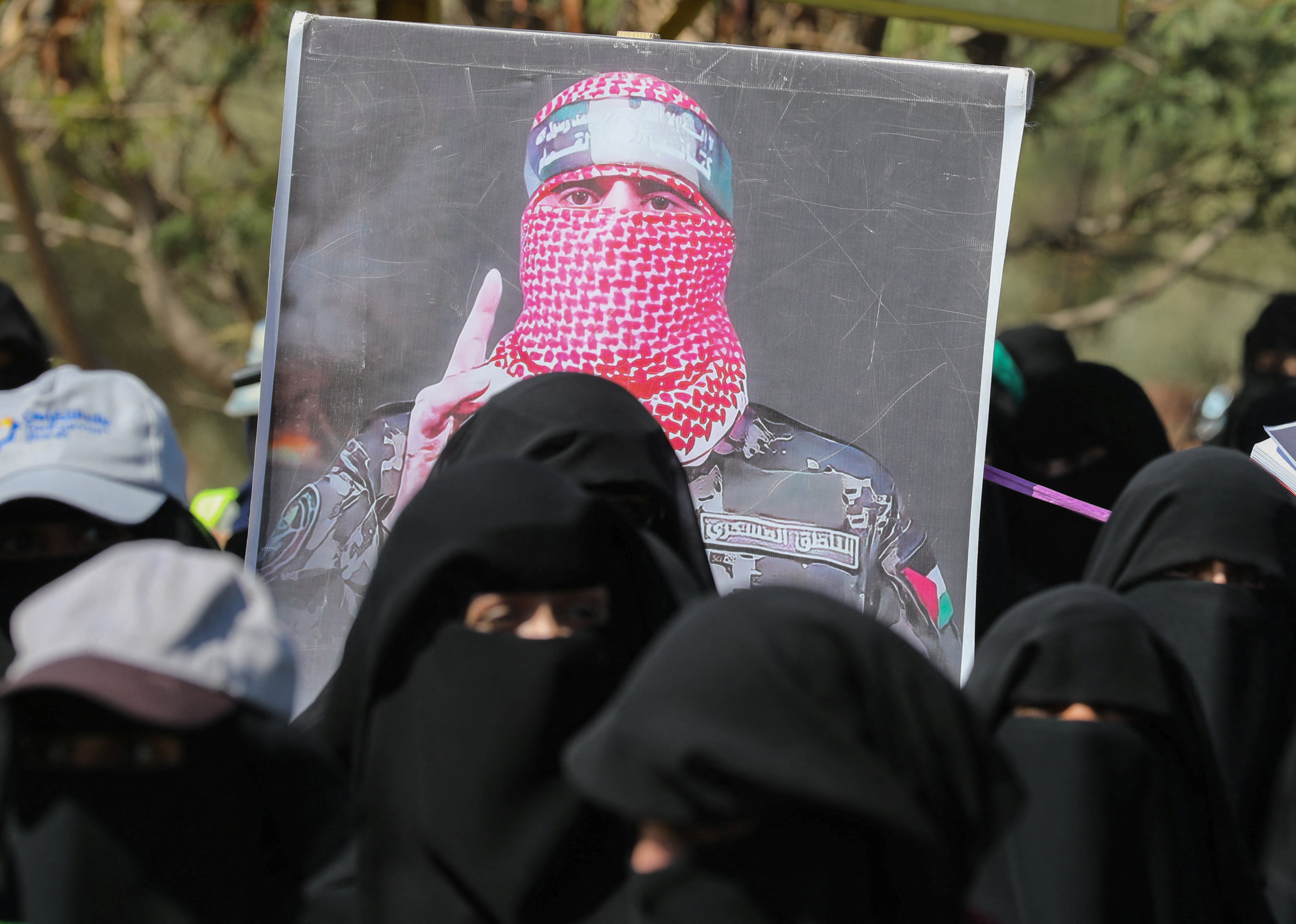 A poster of Abu Ubaida, the spokesman of the al-Qassam Brigades, is carried by university students during a rally to show support for the Palestinians in the Gaza Strip in Sanaa, Yemen, in January. Photo: Reuters
