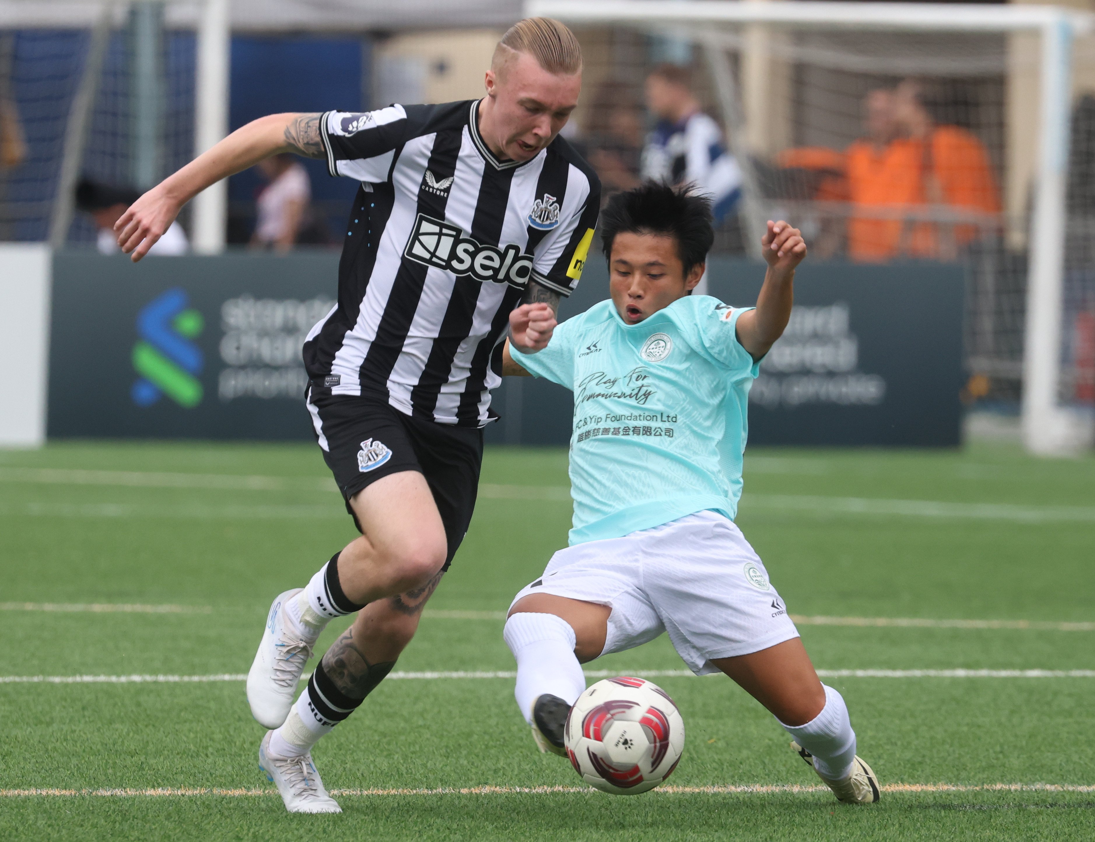 Newcastle United’s Alfe Harrison (left) fights for the ball with Football Club’s Yam Pung-pang at the HKFC Soccer Sevens. Photo: Yik Yeung-man