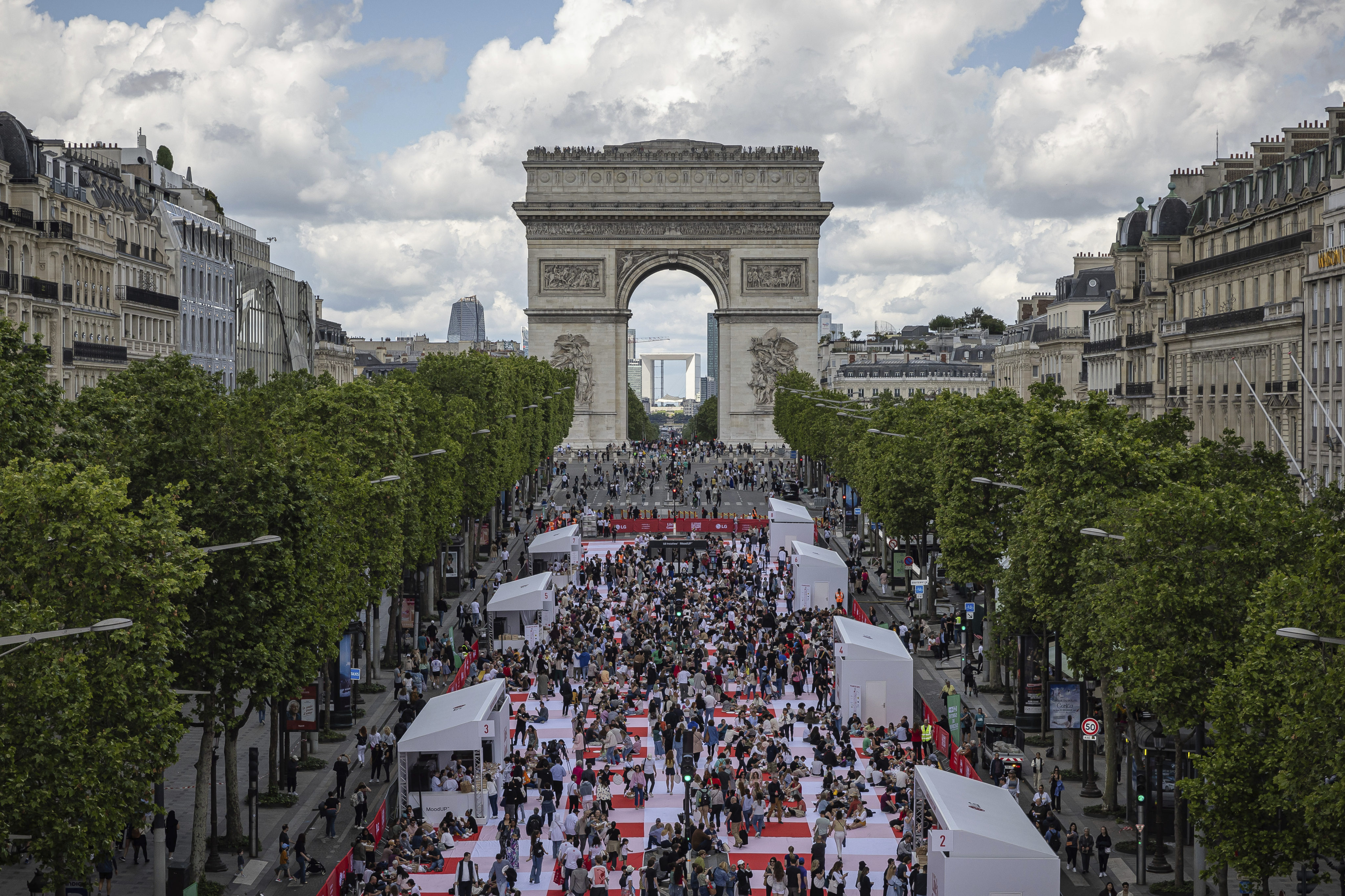 People eat their lunch on the Champs-Elysees on Sunday. Photo: AP