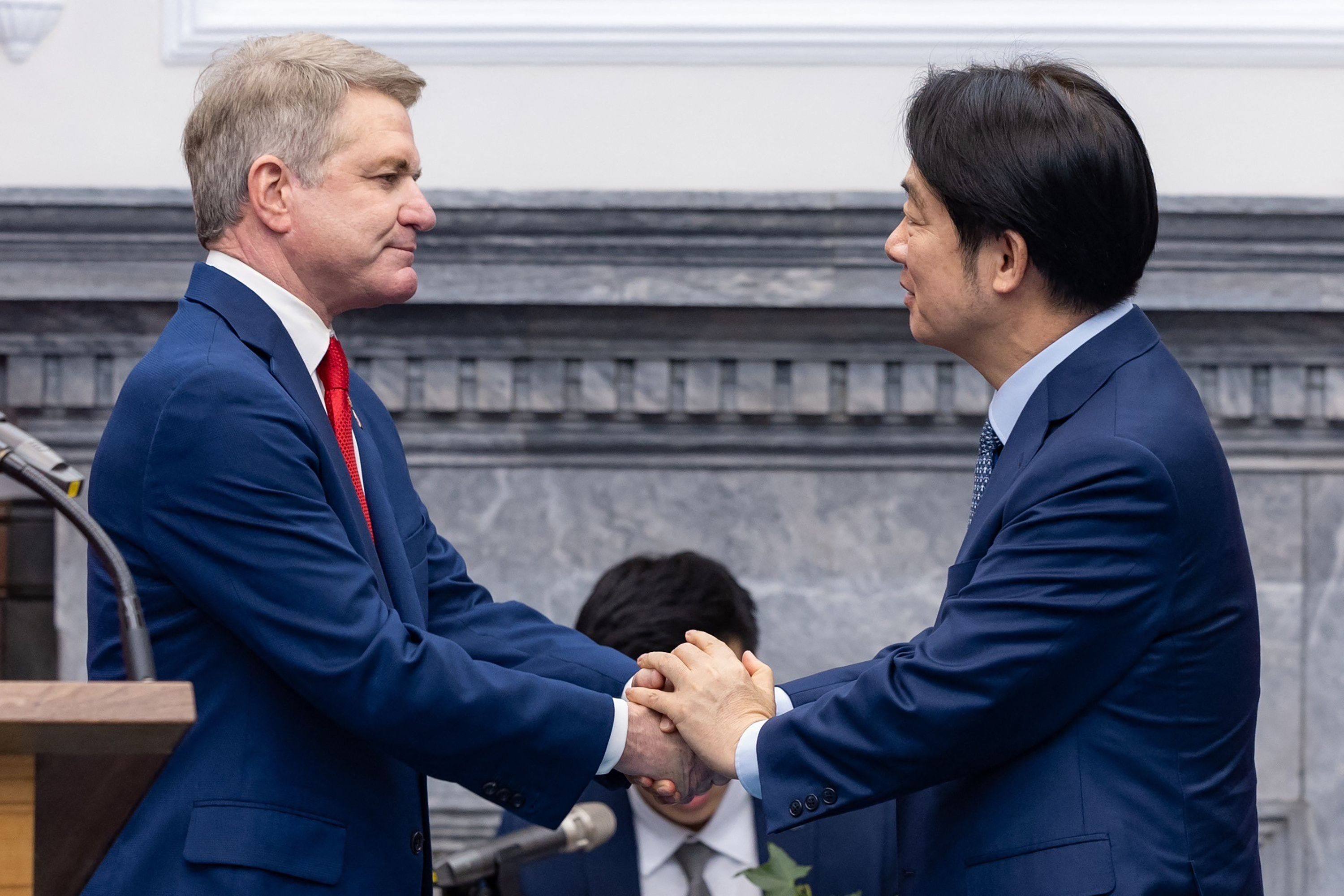 Taiwanese leader William Lai Ching-te (right) greets US Representative Michael McCaul at the Presidential Office in Taipei on Monday. Photo: AFP/Taiwan Presidential Office