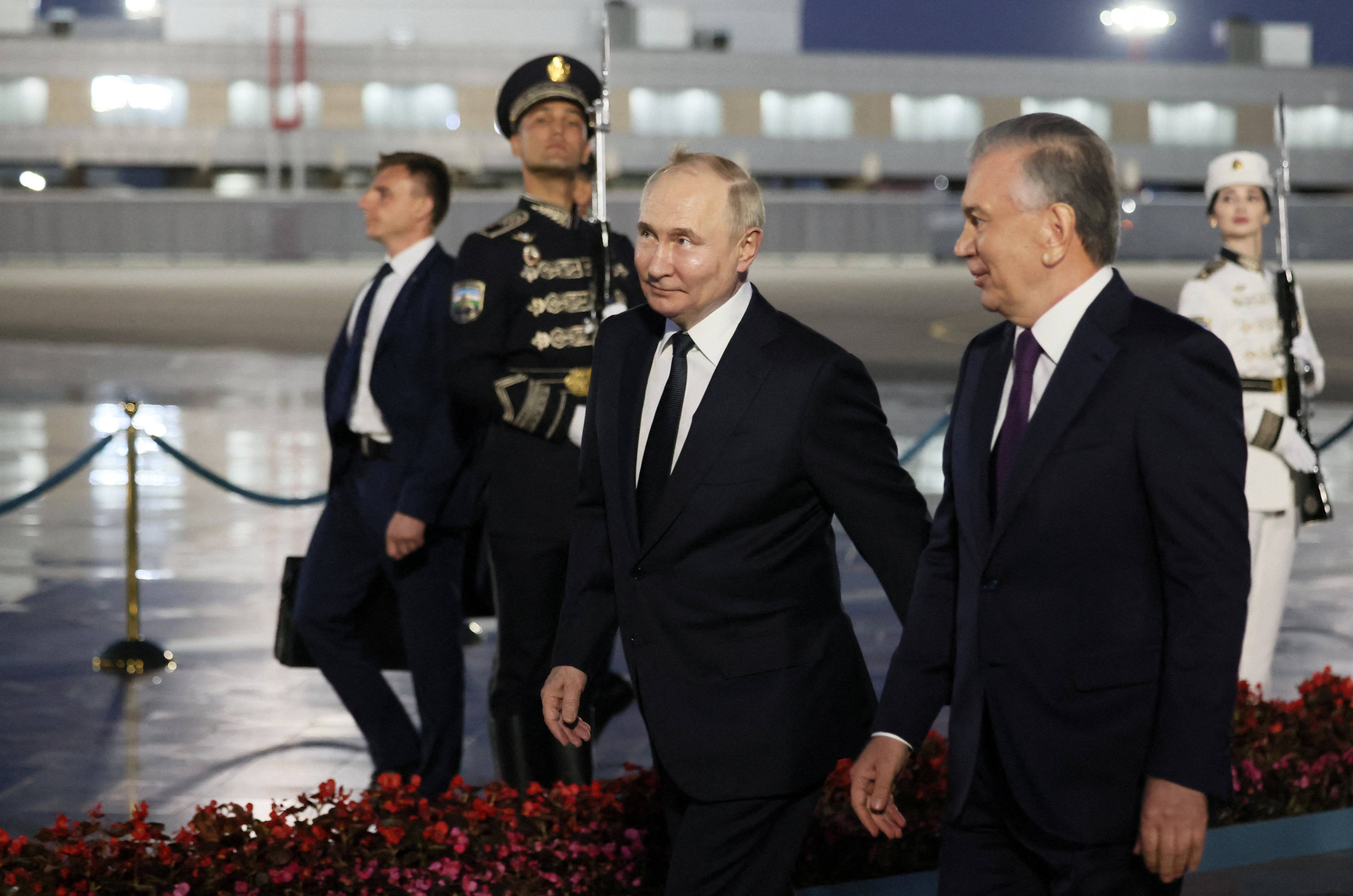 Russian President Vladimir Putin, centre, is welcomed by Uzbek President Shavkat Mirziyoyev at the airport in Tashkent, Uzbekistan on Sunday. Photo: Sputnik / Mikhail Metzel / Pool via Reuters