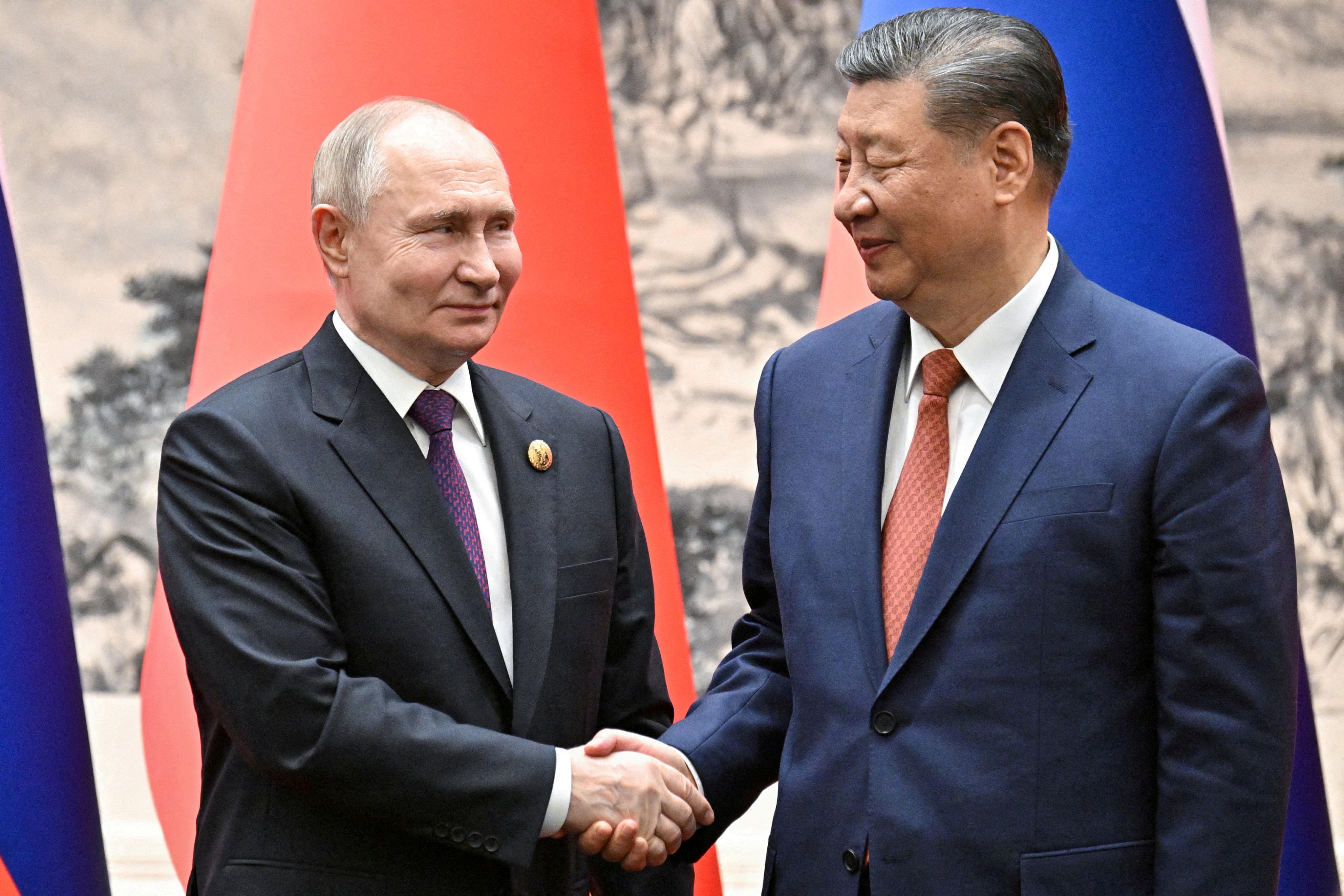 Russian President Vladimir Putin shakes hands with Chinese President Xi Jinping in Beijing. Photo: Reuters