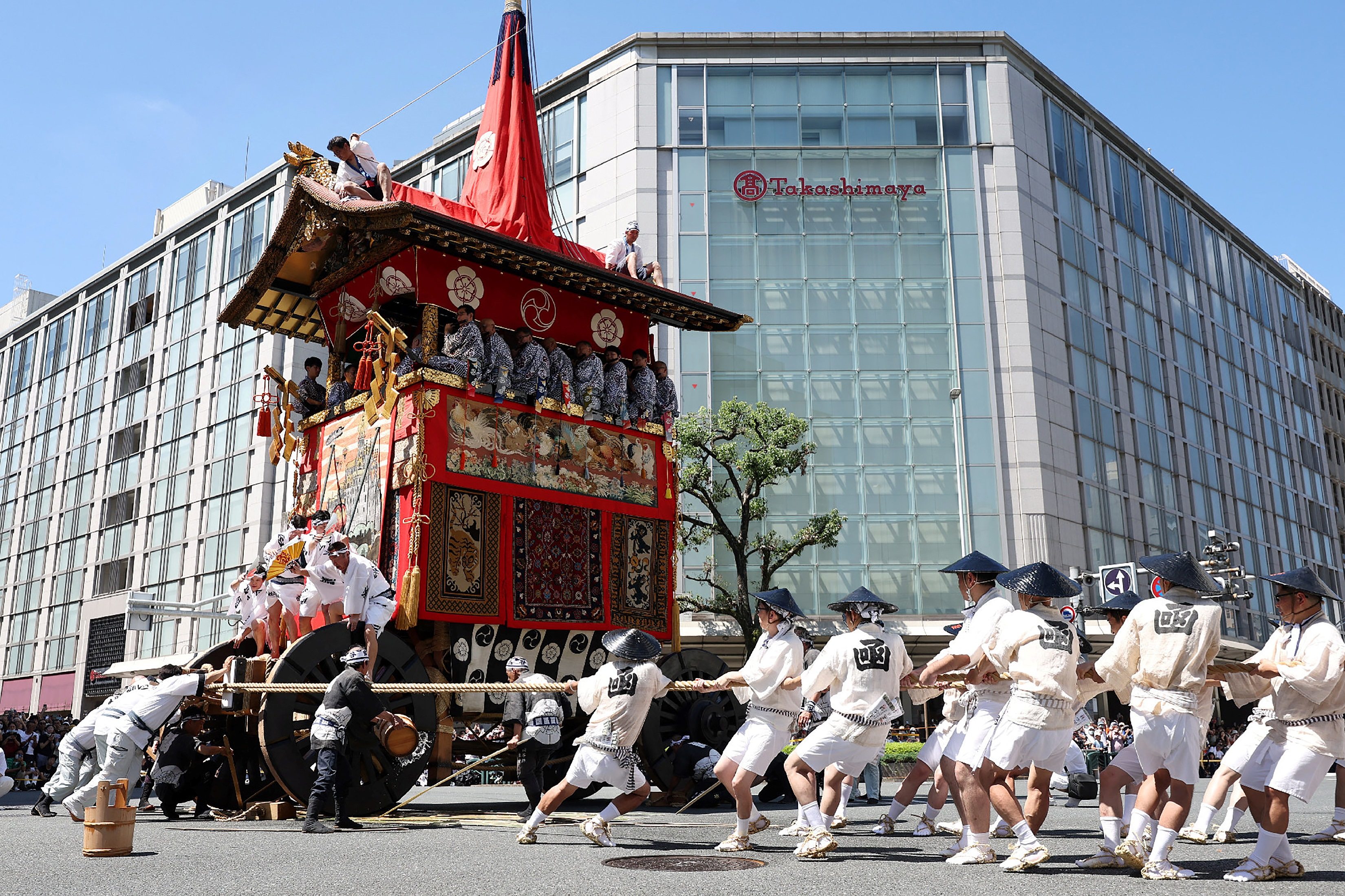 Volunteers pull a giant float through the streets of Kyoto during the Gion Matsuri in July 2023. The summer festival with ancient roots is the most famous in Japan. Photo: AFP