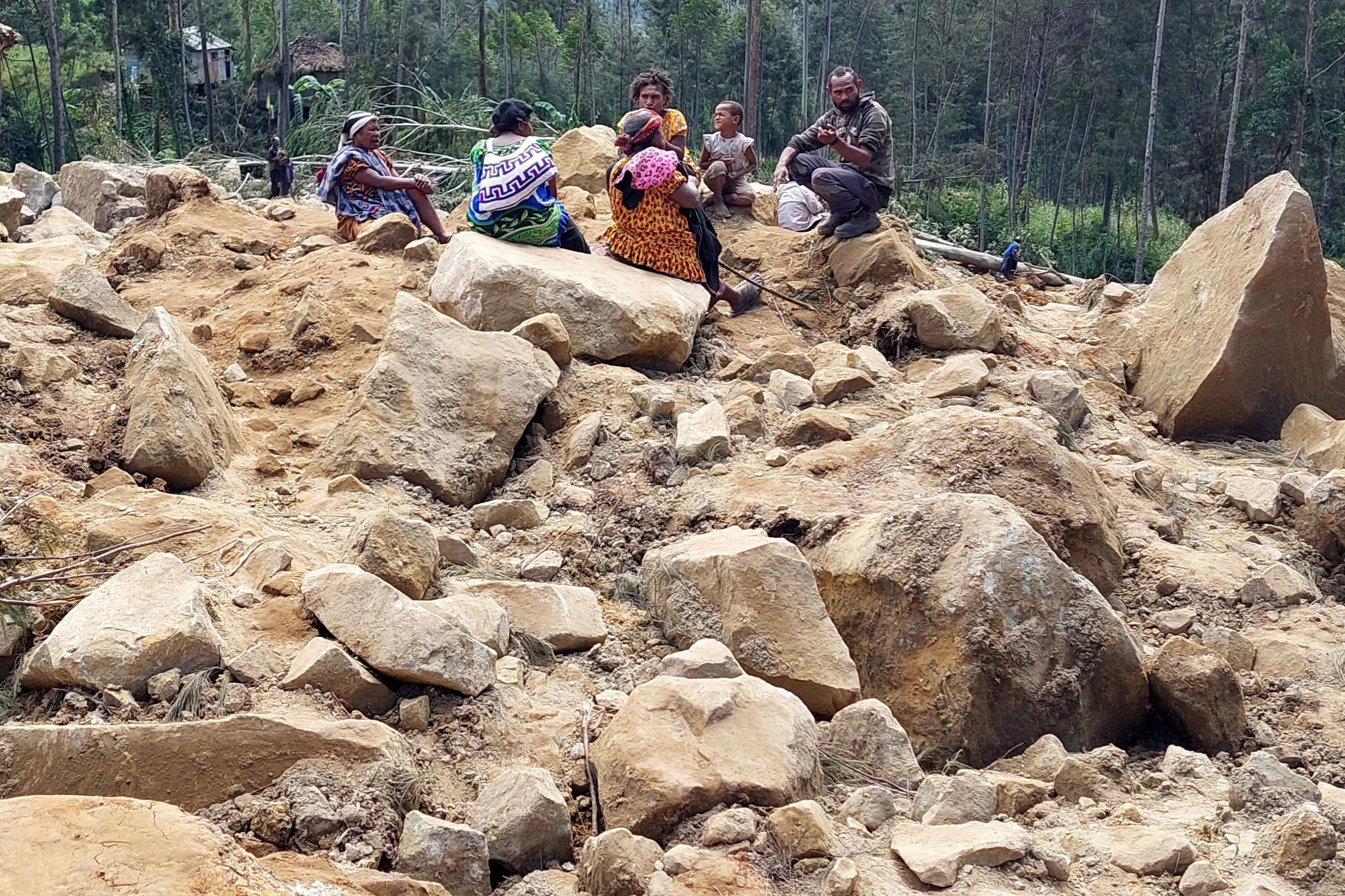Family members of missing villagers are seen at the site of the landslide in Papua New Guinea’s Enga province. Photo: AFP